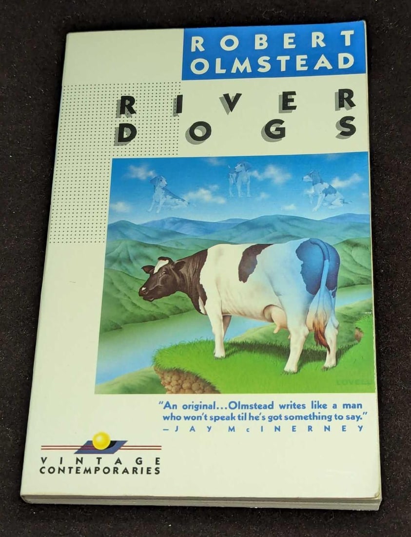 Robert Olmstead Signed River Dogs First Edition Paperback: Robert Olmstead Signed River Dogs First Edition Paperback. This was published by Vintage Contemporaries (New York) in the year 1987. The paperback is approx 5 1/8" x 1/2" x 8" and it weigh