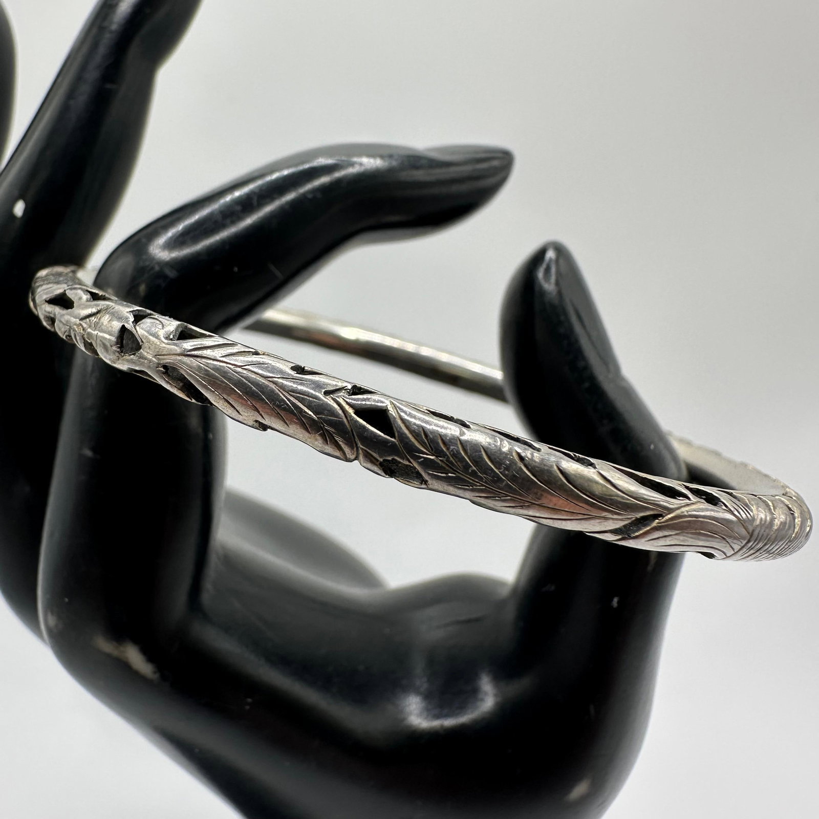 Intricate Engraved Leaf Vine Scroll Openwork Silver Bangle Bracelet M24: This item is in good pre-owned, previously used/displayed condition with noticeable light wear and surface scratches. Please reference all photos for full details. This piece of jewelry has been teste