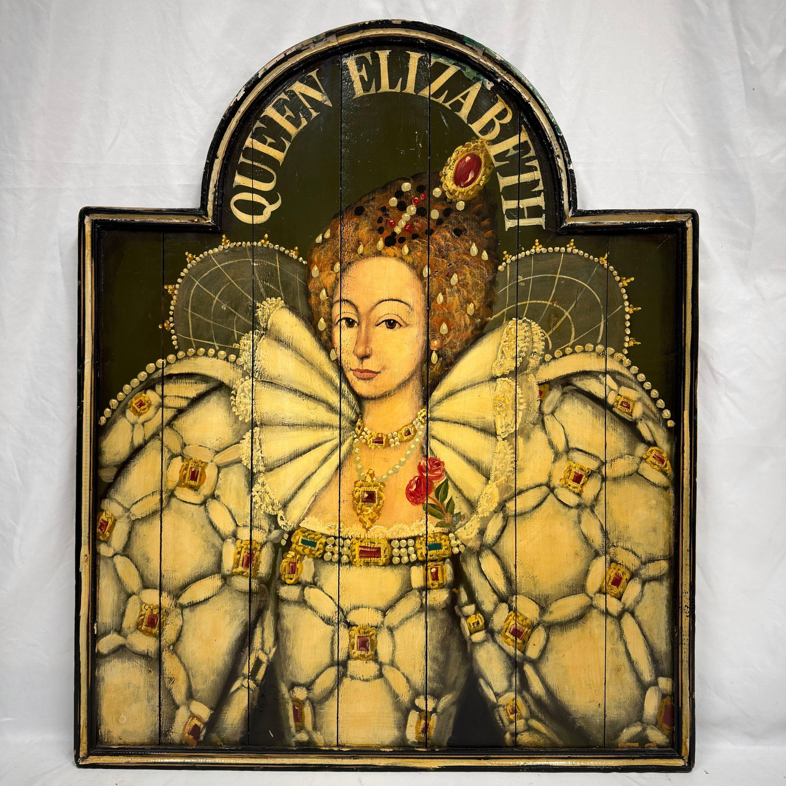 Large Folk Art Painted Wooden Panel of Queen Elizabeth I: Large hand-painted folk art wall panel depicting Queen Elizabeth I in elaborate Tudor attire beneath an arched top bearing the inscription "Queen Elizabeth." Painted on joined wooden planks wi
