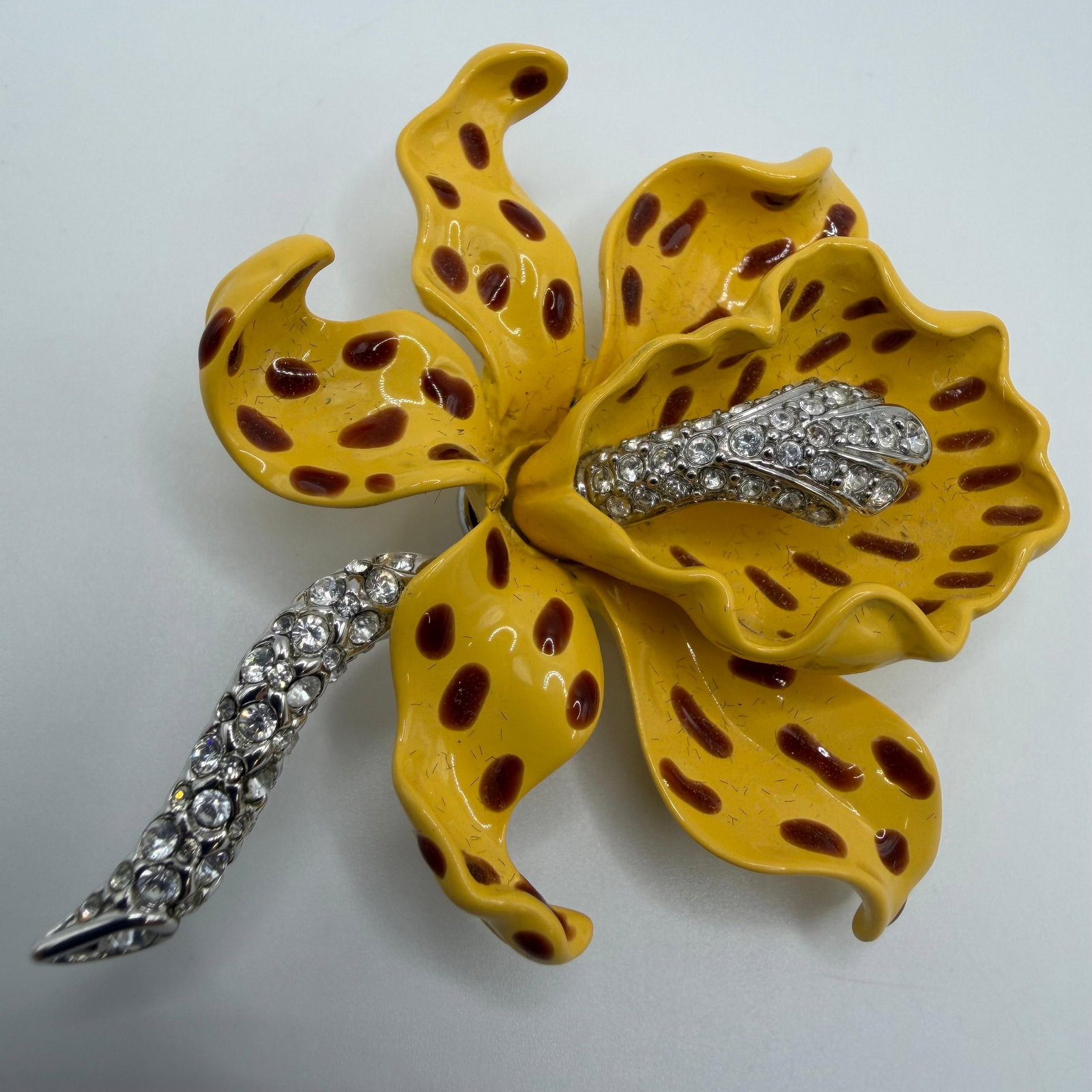 KJL Kenneth Jay Lane Yellow Orchid Bold Yellow Enamel and Crystal Accents: This is a Kenneth Jay Lane yellow orchid brooch featuring yellow and brown enamel combined with dazzling crystal pave. Reverse marked KJL. This item is pre-owned, with light wear, minor imperfections,