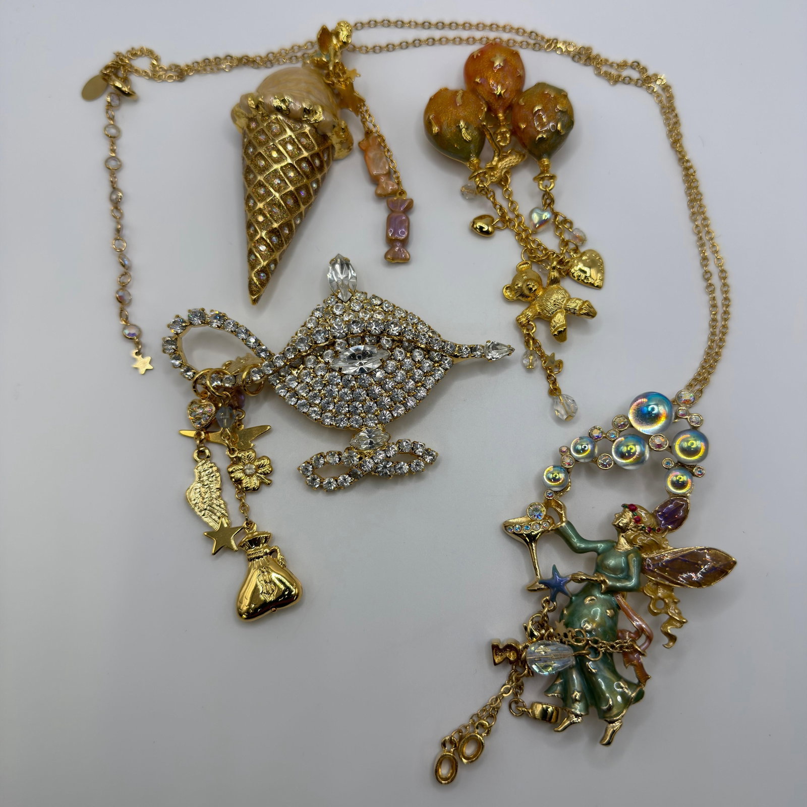 Kirks Folly Fantasy Jewelry Group Fairy Necklace Genie Lamp Ice Cream Cone Brooch: Collection of signed Kirks Folly fantasy-themed costume jewelry. Includes a whimsical fairy pendant necklace, rhinestone genie lamp brooch, ice cream cone brooch, and balloon brooch with teddy bear. G