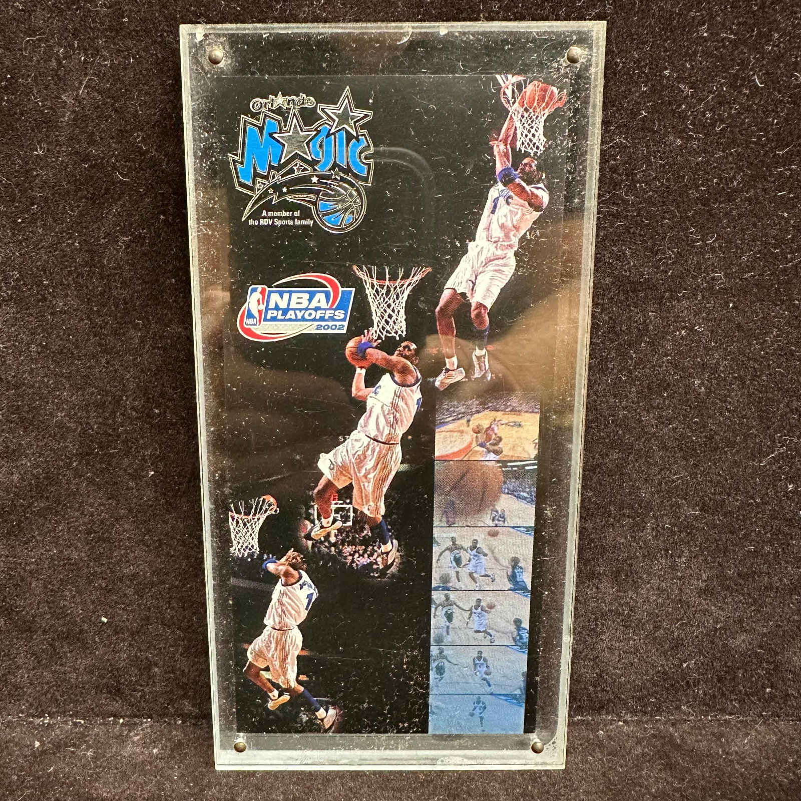 Orlando Magic NBA Playoffs 2002 Acrylic Display Plaque: Commemorative Orlando Magic acrylic display plaque featuring action imagery from the 2002 NBA Playoffs. The front panel showcases multiple dunk and in-game action shots with Orlando Magic branding and