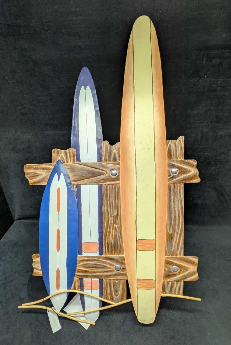 Surfboard Wall Art Beach Decor: Surfboard Wall Art Beach Decor This is a like-new metal wall decoration of surfboards resting on a fence. This is a great piece for a beach-themed home. This comes with a small kit to hang the item on