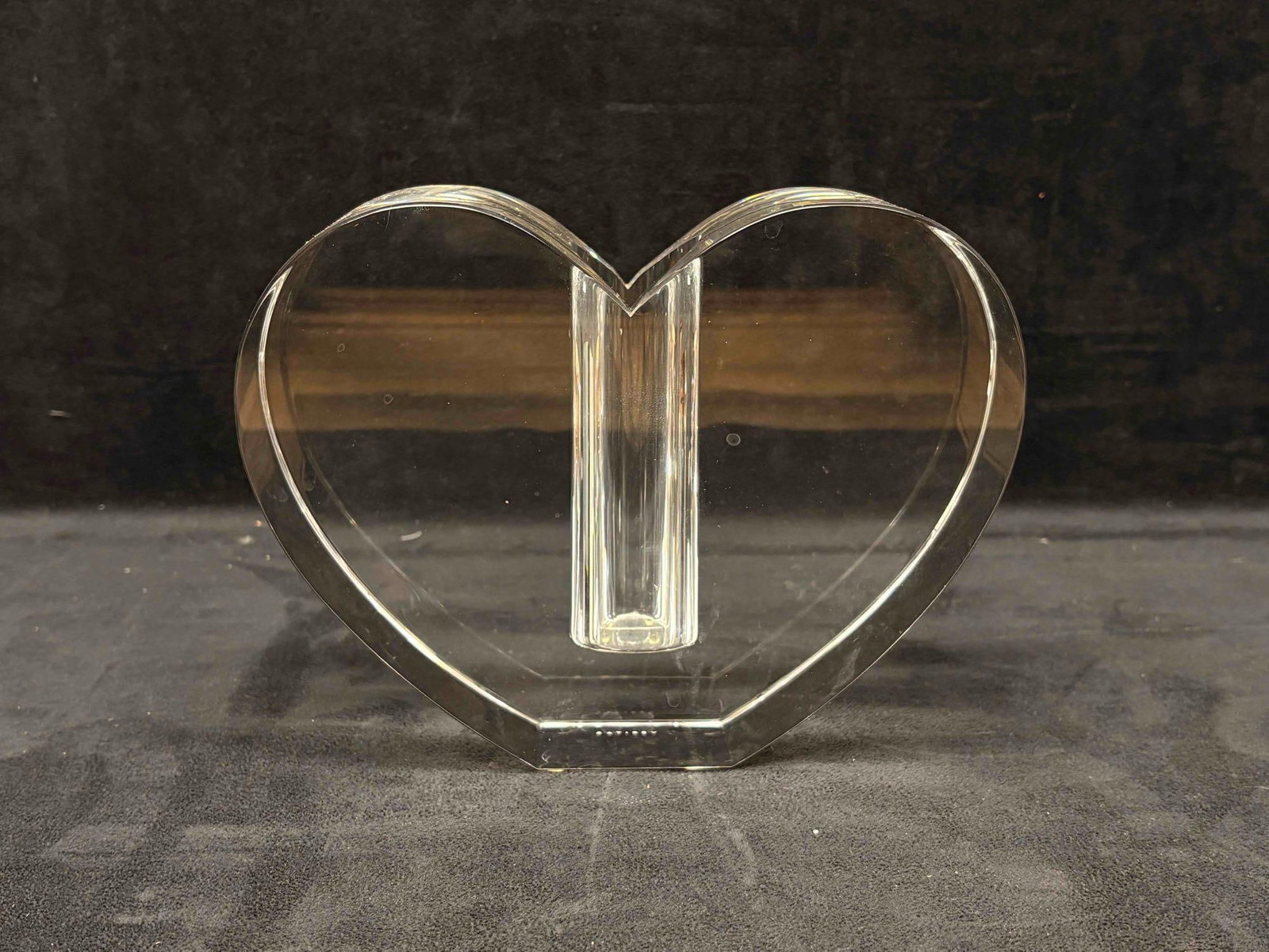 Crystal Clear Glass Heart-Shaped Display Stand or Bud Vase: This lot includes one crystal clear heart-glass vase, holding just enough space for a singular rose. No brandishing or sticking specifying manufacturer can be found on the item itself. However, it sta
