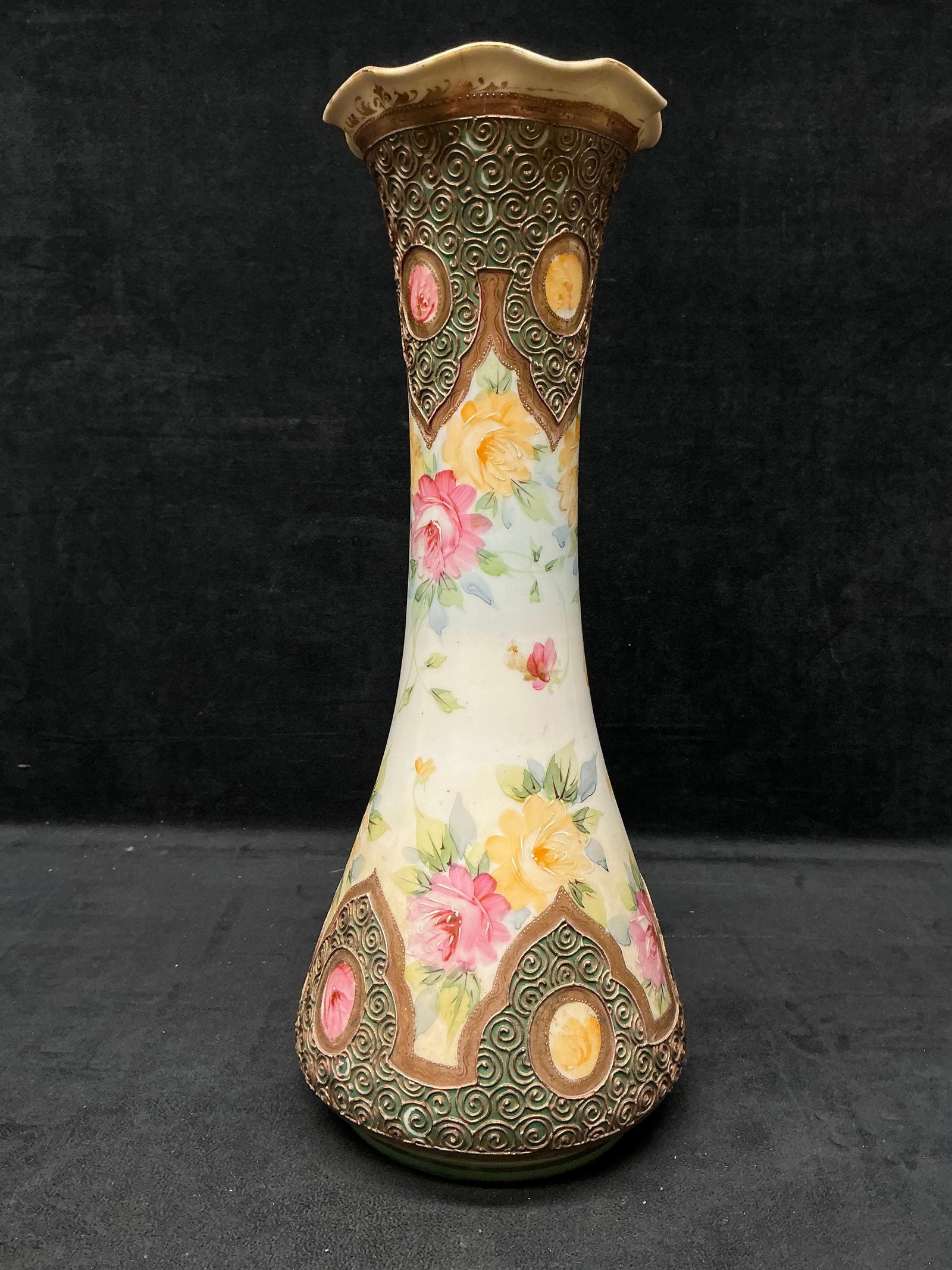 20th Century Nippon Style Porcelain Floral Vase with Reflective Gold Accents: The central body of this lot is adorned with pink and yellow seemingly hand-painted floral designs. Accented by reflective gold paint that is fading minimally along the rim of the vase's opening. 