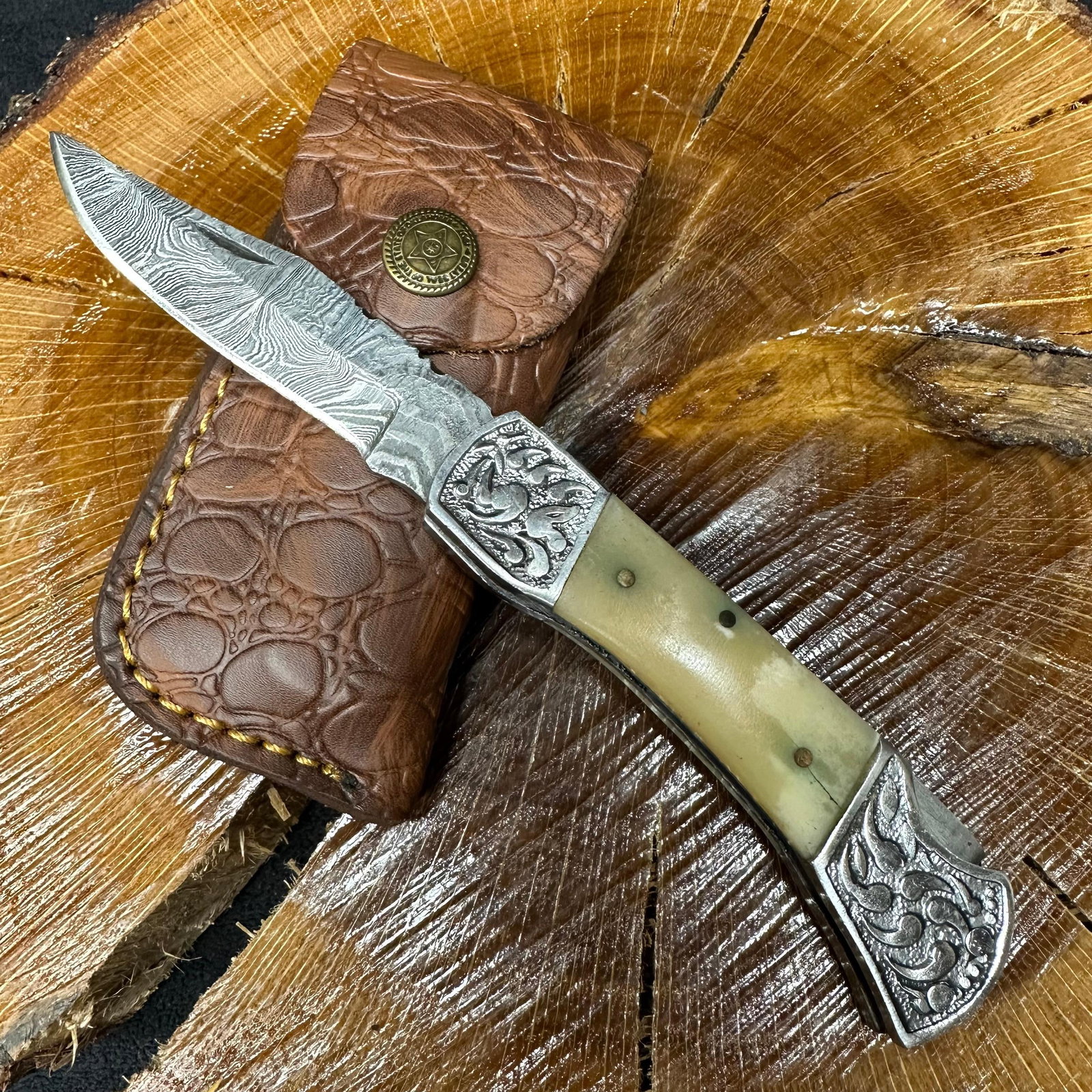 MHS Cutlery Steel Layered Patterned Folded Blade Pocket Knife Q81: Folding blade pocket knife by MHS Cutlery featuring a layered patterned steel blade and decorative spine work. The handle has a contoured, wood/resin-style grip with metal mosaic pin accents. Includes
