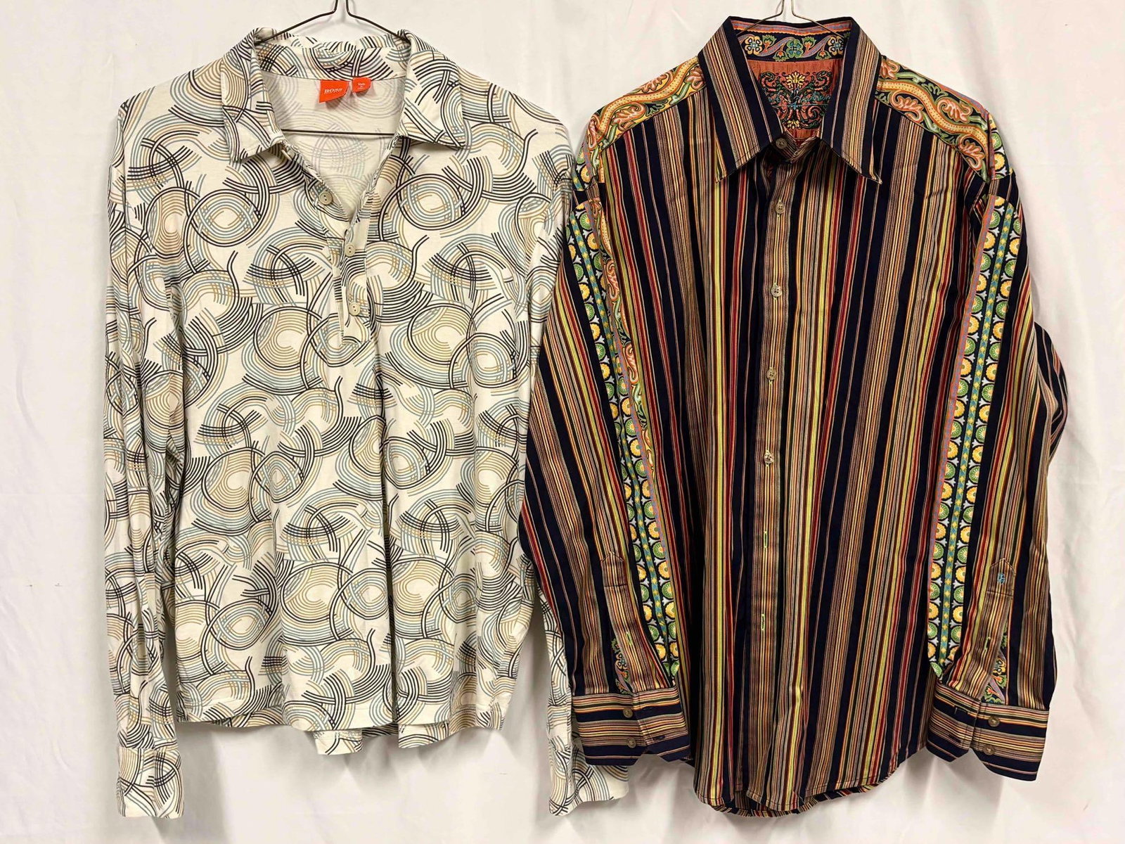 2PC Hugo Boss and Robert Graham Retro Geometric Print Mens Shirt Bundle: This lot contains a set of men's short sleeve dress shirts. Both the Robert Graham and Hugo Boss shirts are a size Large, standing in like-new conditions without tags. Please refer to images for
