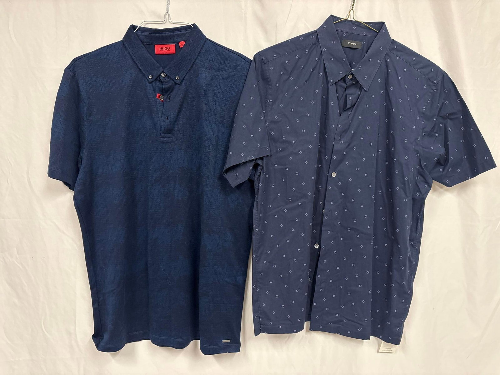 2PC Hugo Boss and Theory Casual Navy Blue Mens Shirt Bundle: This lot contains a set of men's short sleeve dress shirts. Both the Hugo Boss and Theory shirts stand in like-new conditions without tags. Please refer to images for further context on the
