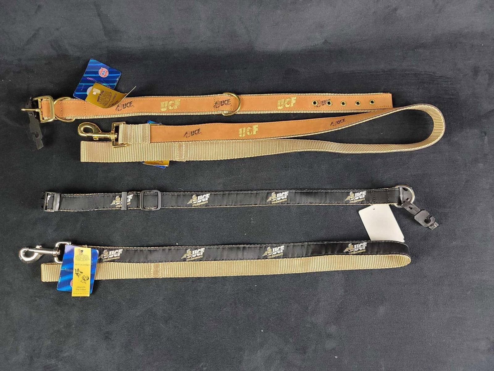UCF Football Dog Collars and Leashes A: Lot contains 2 collars and leashes: 1- UCF, black with knight logo, Size L, made in the USA by Zep Pro. length collar 26", leash length 4' 1- UCF, tan and gold, leather, Size L, Made in