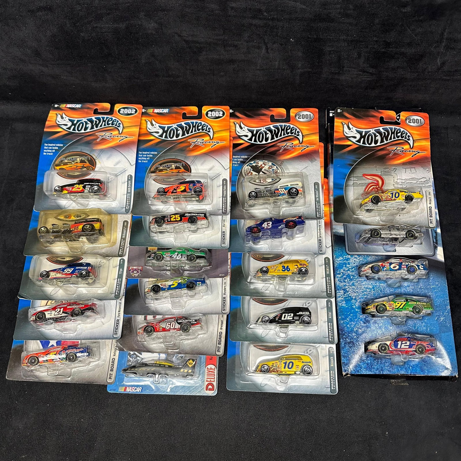 Hot Wheels Racing NASCAR Die-Cast Cars Collection 21 2000s: Group of Hot Wheels Racing NASCAR die-cast cars on original cards dated 2001–2002. Includes multiple drivers and sponsors such as Kellogg’s, Nesquik, Valvoline, John Deere, Grainger, Marin