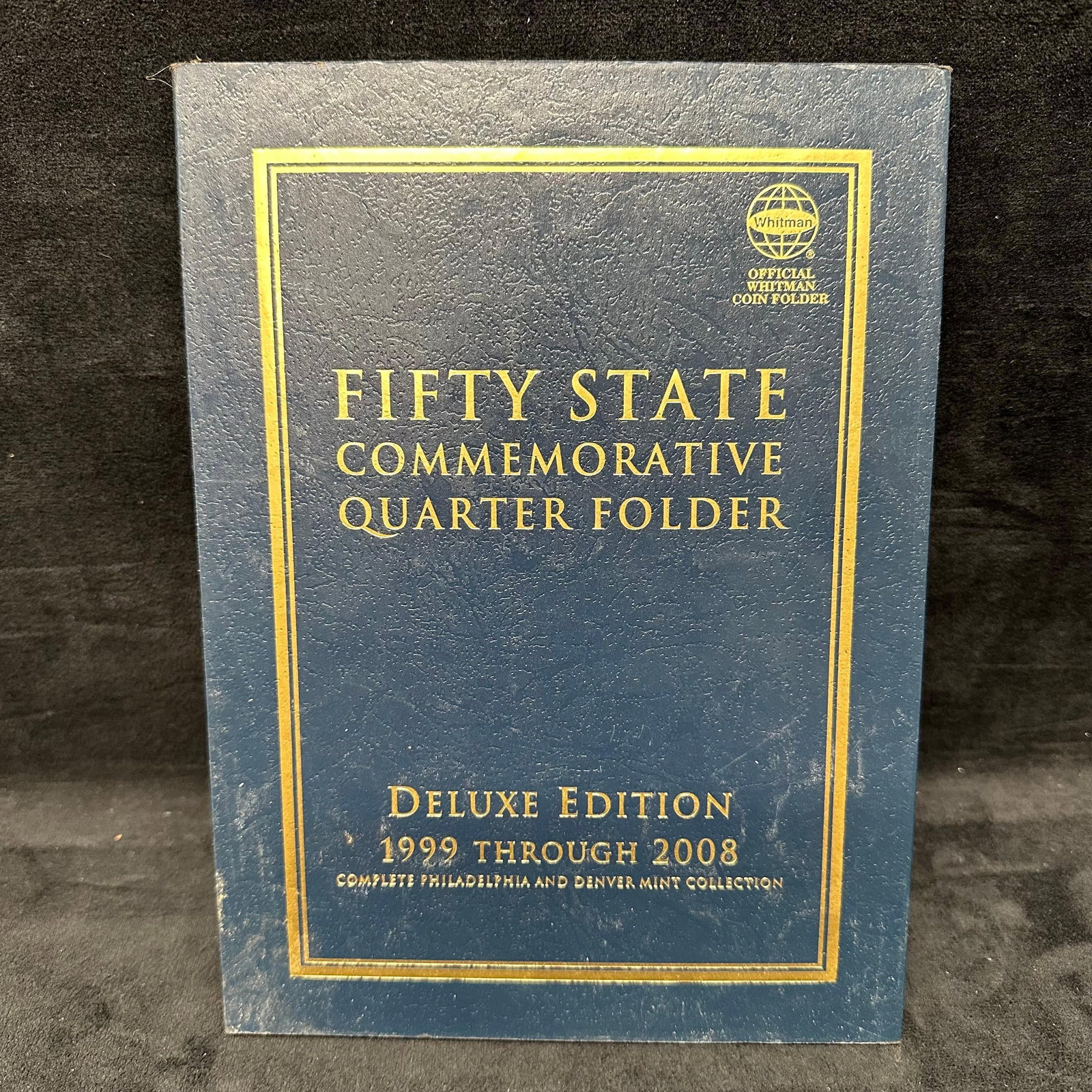 Fifty State Commemorative Quarter Folder 1999-2008 99 Quarters: Coin folder featuring 99 US State Quarters from 1999-2008. These items are in pre-owned, previously used/displayed condition with noticeable light wear and surface scratches. Coins appear to have mini