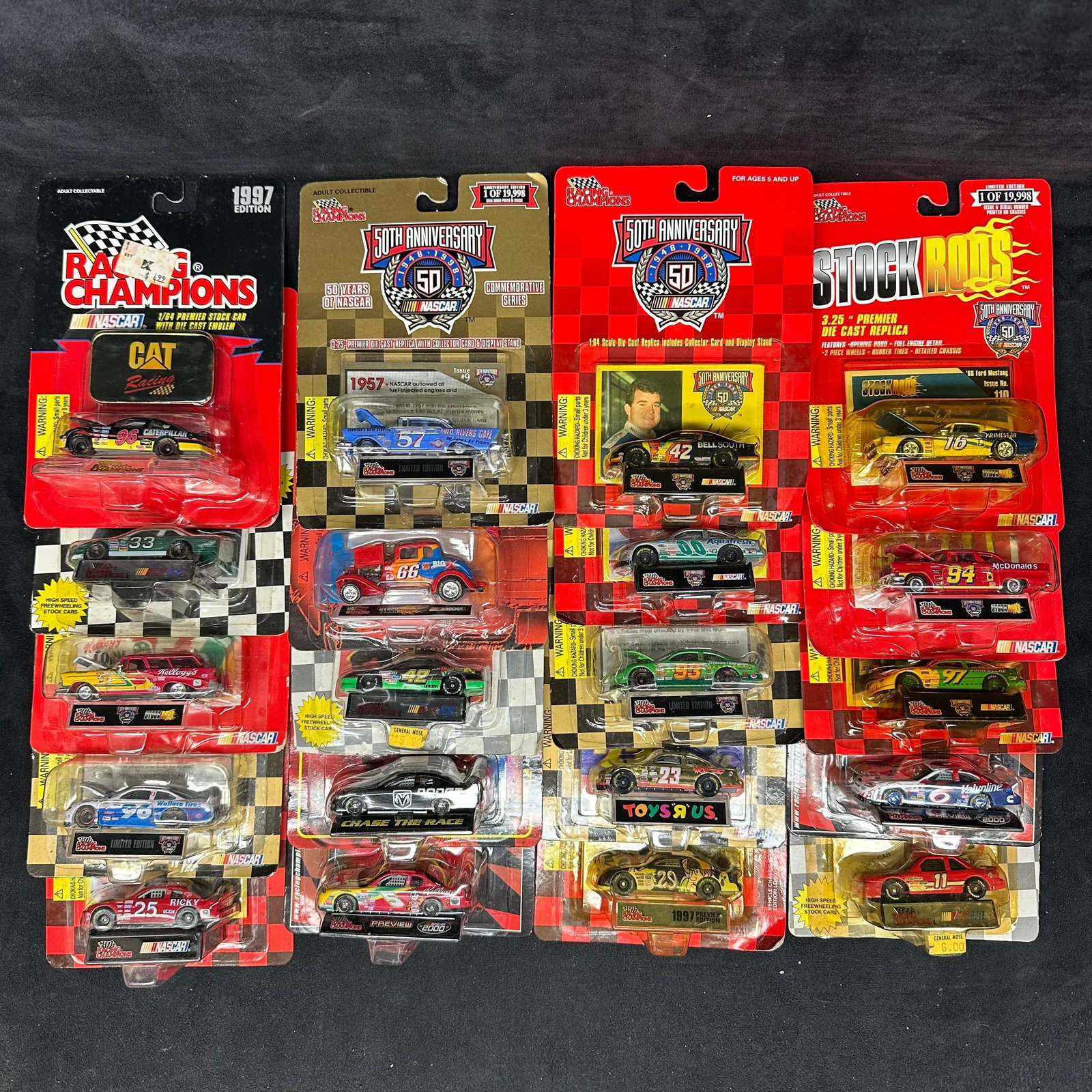 20 Racing Champions NASCAR Diecast Car Collectibles 1:64 Scale: Group of 20 Racing Champions NASCAR diecast cars, mostly 1:64 scale and carded. Cars remain sealed in original blister packaging with display cards. Some card wear and bending are consistent with stor