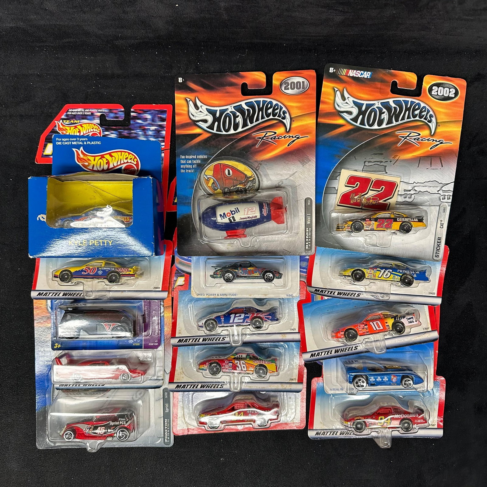 Hot Wheels Racing NASCAR Diecast Car Lot 2000s Blimp Kyle Petty McDonald’s: Group of Hot Wheels Racing diecast vehicles, primarily NASCAR themed, on original cards dated 2001–2002. Includes multiple drivers and sponsors such as #94 McDonald’s, #36 Skittles, #12 Mo