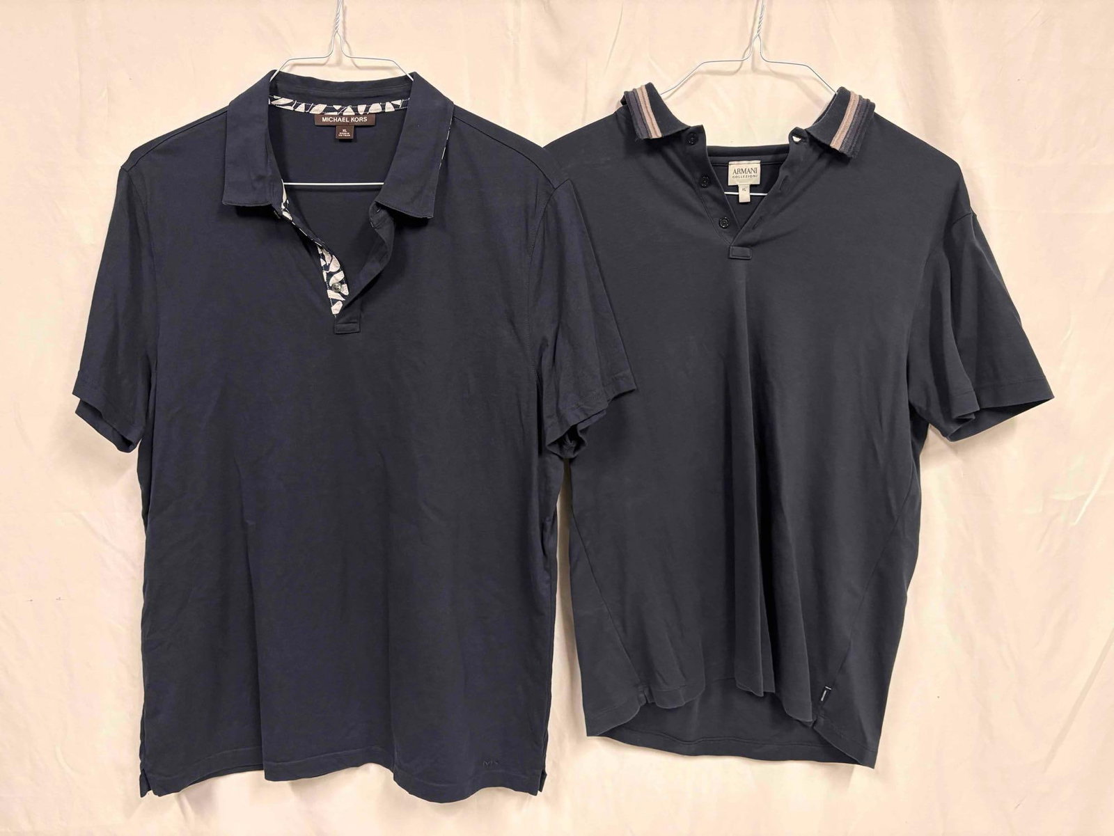 2PC Michael Kors and Armani Exchange Navy Blue Mens Polo Shirt Bundle: This lot contains a set of men's short sleeve dress shirts. Both the Michael Kors and Armani Exchange shirts stand in like-new conditions without tags. Please refer to images for further context o