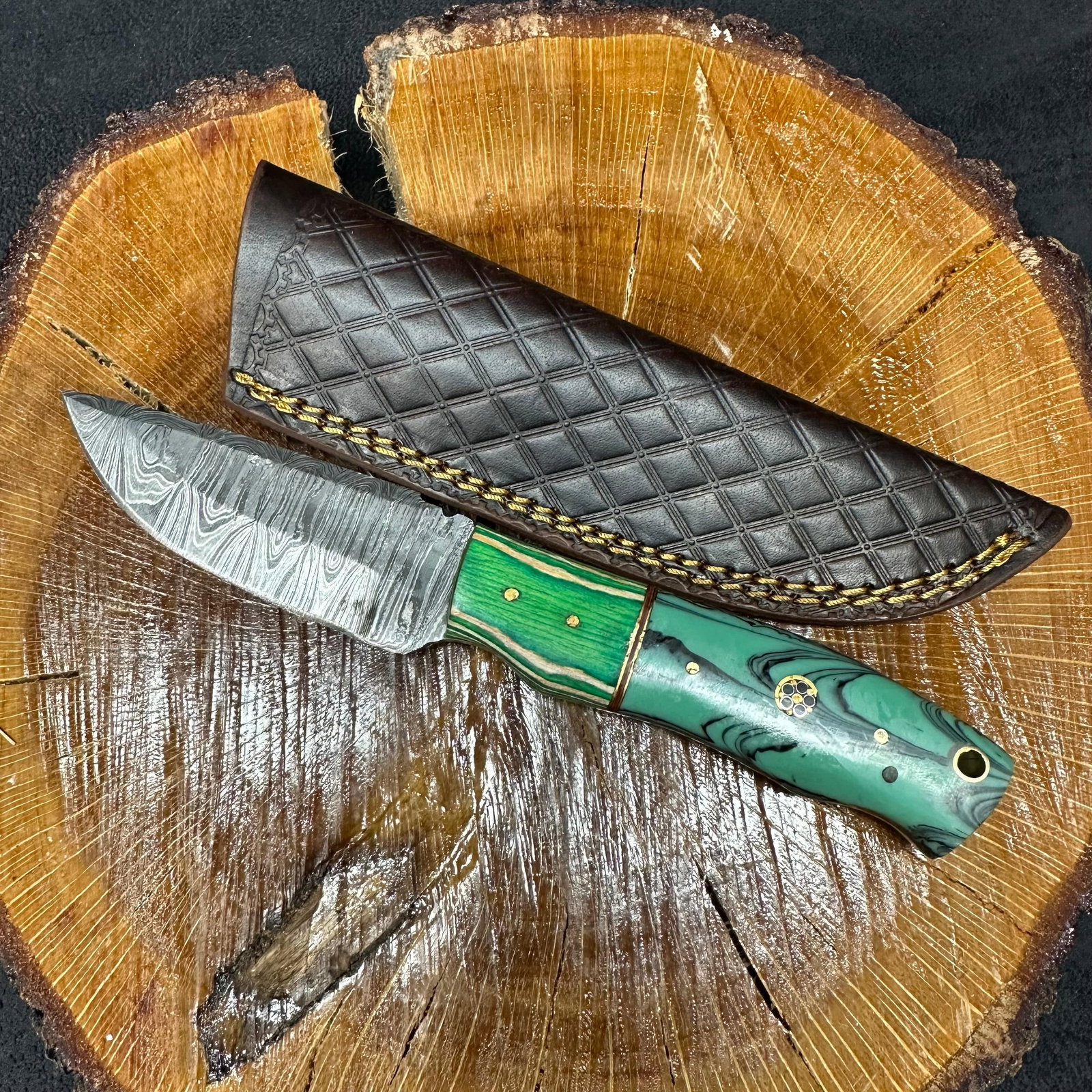 MHS Cutlery Blade Knife Unique Designed Handle Q19: Fixed blade knife by MHS Cutlery featuring a layered patterned steel blade and decorative spine work. The handle has a contoured, multi-colored wood/epoxy resin-style grip with metal mosaic pin accent