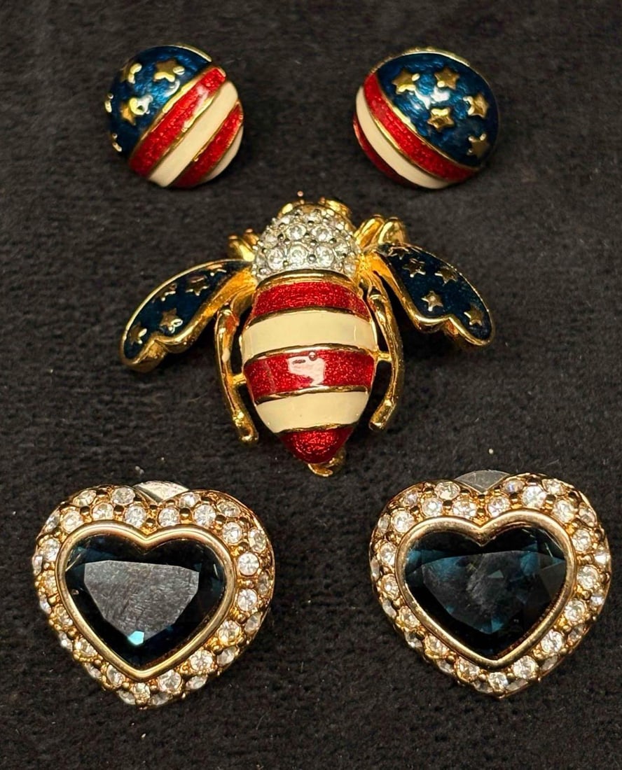 Joan Rivers Patriotic Bee Brooch and Clip-On Earrings Group 3pc F: Joan Rivers costume jewelry group, including an American flag enamel bee brooch, a pair of patriotic enamel clip-on earrings, and a pair of blue heart-shaped crystal and rhinestone clip-on earrings. G