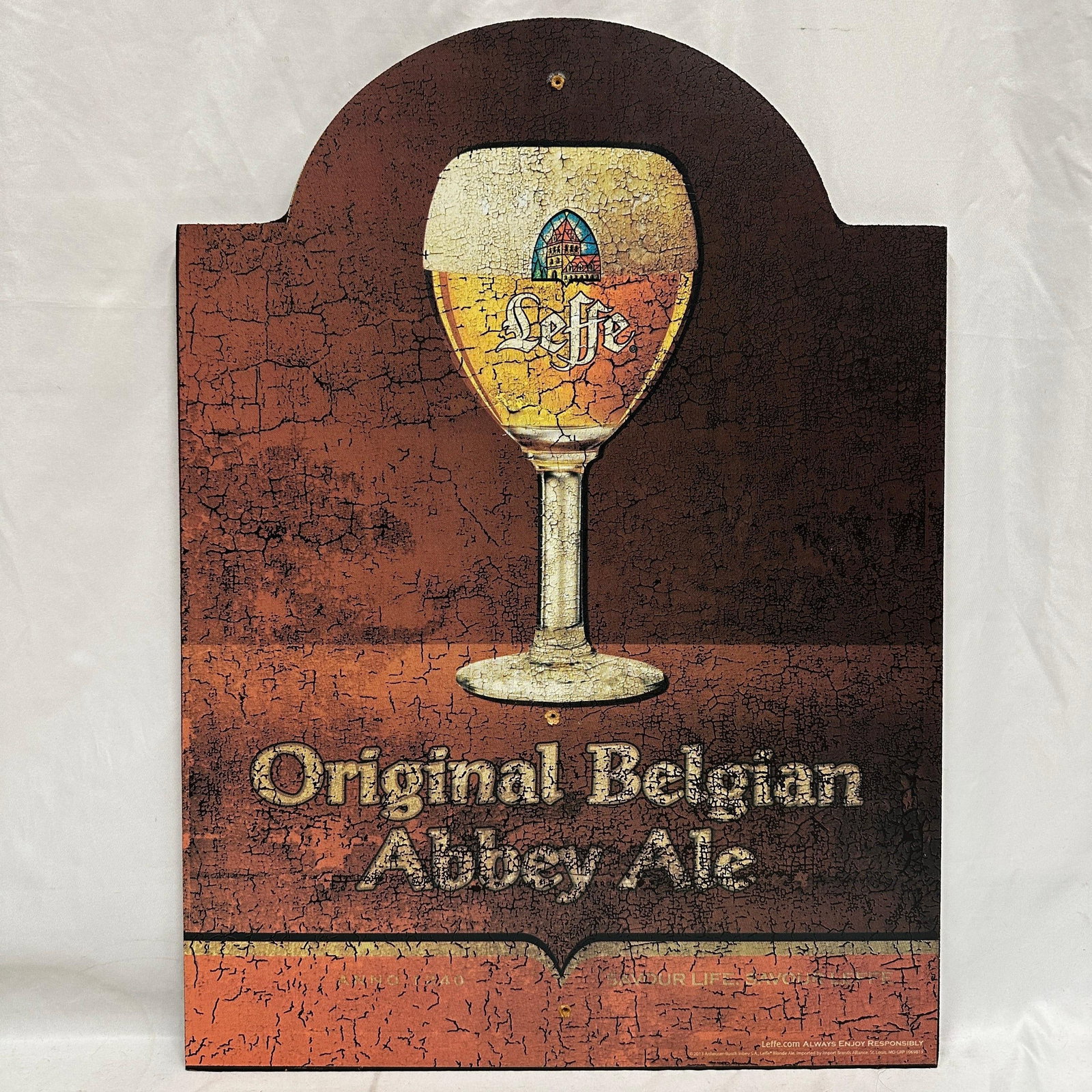 Leffe Belgian Abbey Ale Wooden Bar Sign Beer Ad Plaque: Decorative wooden bar sign featuring Leffe Belgian Abbey Ale branding with chalice glass design and Original Belgian Abbey Ale text. Arched top plaque with crackle-style printed finish. Shows light