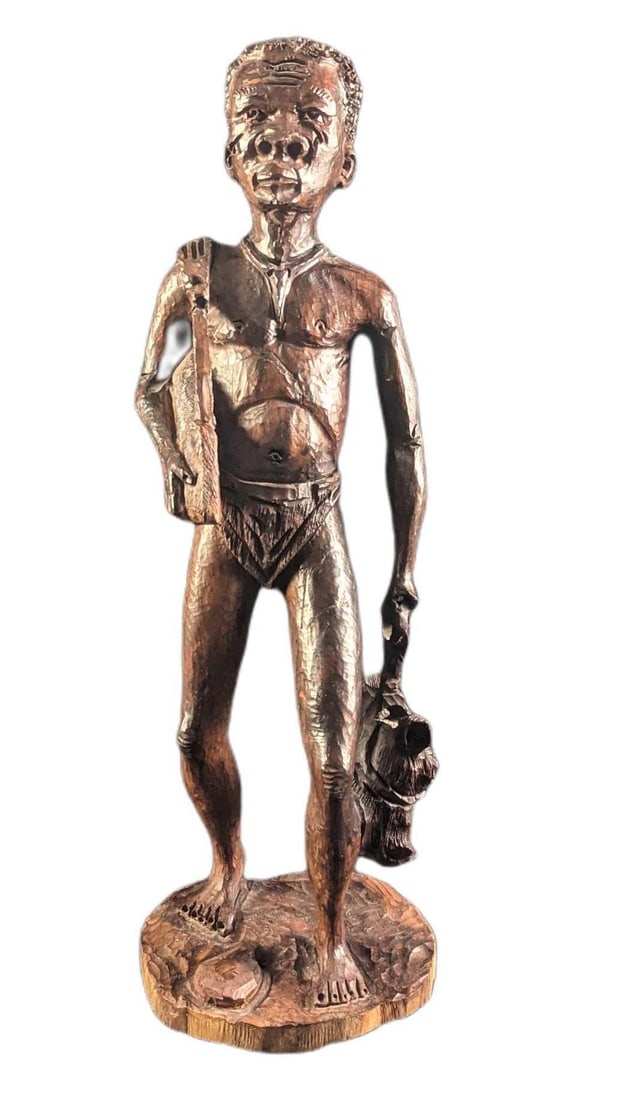 Large Hand Carved Wooden Tribal Hunter Statue: Large Hand Carved Wooden Tribal Hunter Statue. The maker and date of creation are unknown. Is approx 6" x 5" x 17 1/2" and it weighs 3.28lbs. The statue is in a good, used condition with a fixed 