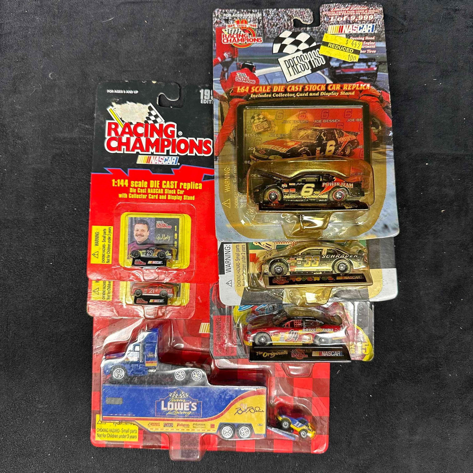 Racing Champions NASCAR Die-Cast Collectible Cars and Haulers: Lot of assorted Racing Champions NASCAR die-cast collectibles including various scales and series. Features 1:64 scale stock cars, a 1:144 scale car with display card, and a Lowe’s Racing Team h