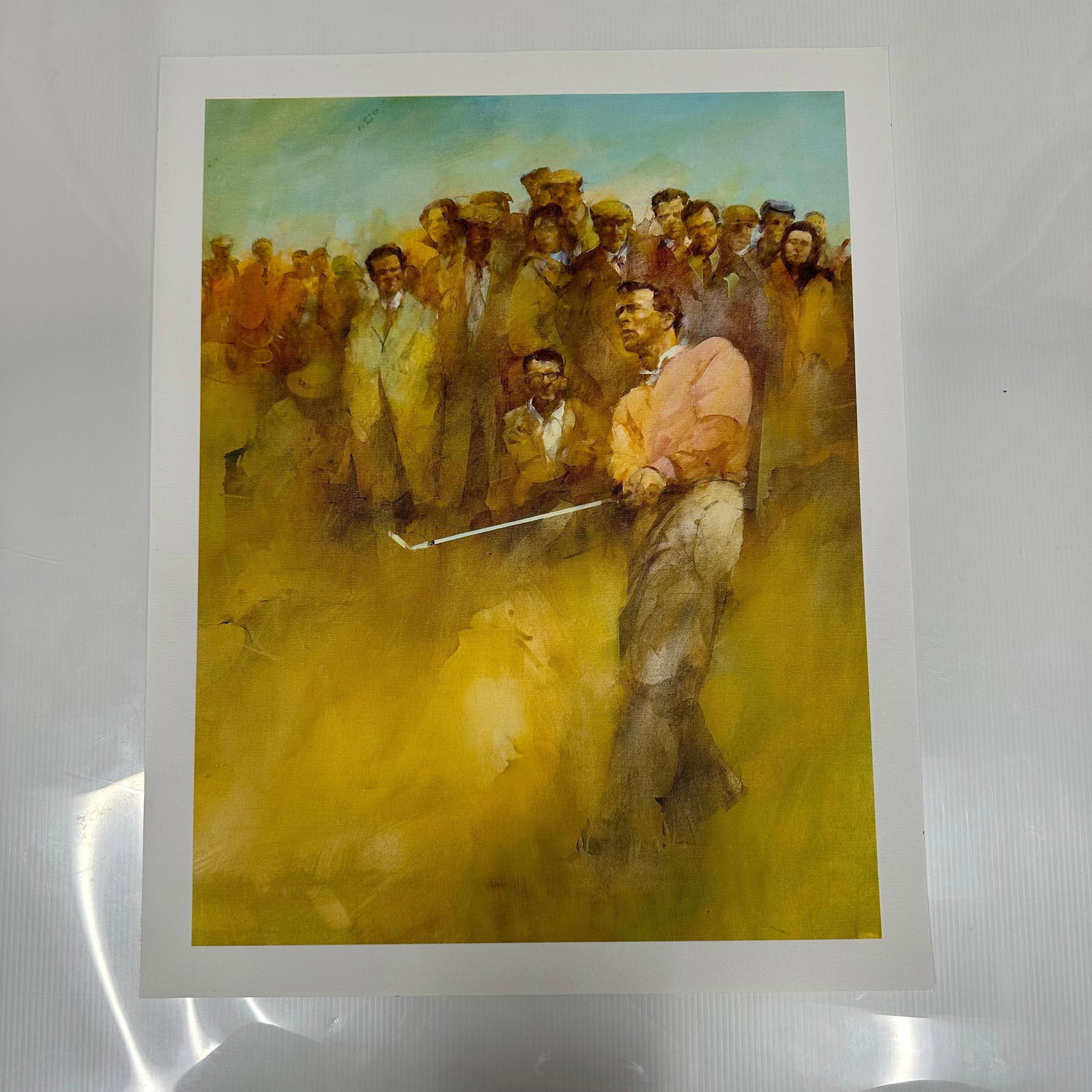 Arnold Palmer Giclee Art Print of Golfer with Spectators Printed on Canvas Textured Paper: Giclee art print depicting a golfer, Arnold Palmer, mid-swing with a crowd of spectators in the background. Printed on canvas-textured paper. The image presents a painterly, impressionistic style with