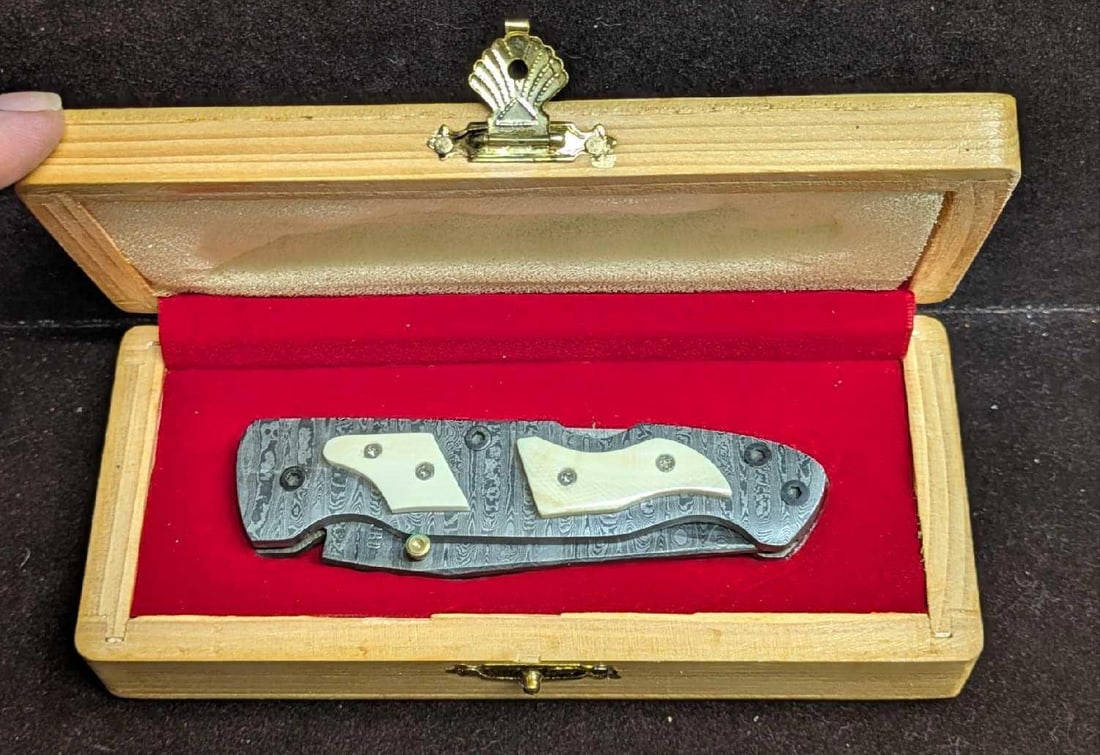 Damascus Steel Fold Up White Bone Handle Knife Retired: Damascus Steel Fold Up White Bone Handle Knife Retired. Here is a fold-up knife made of imported Damascus steel with a white natural bone handle. These were made in very limited batches by a small com