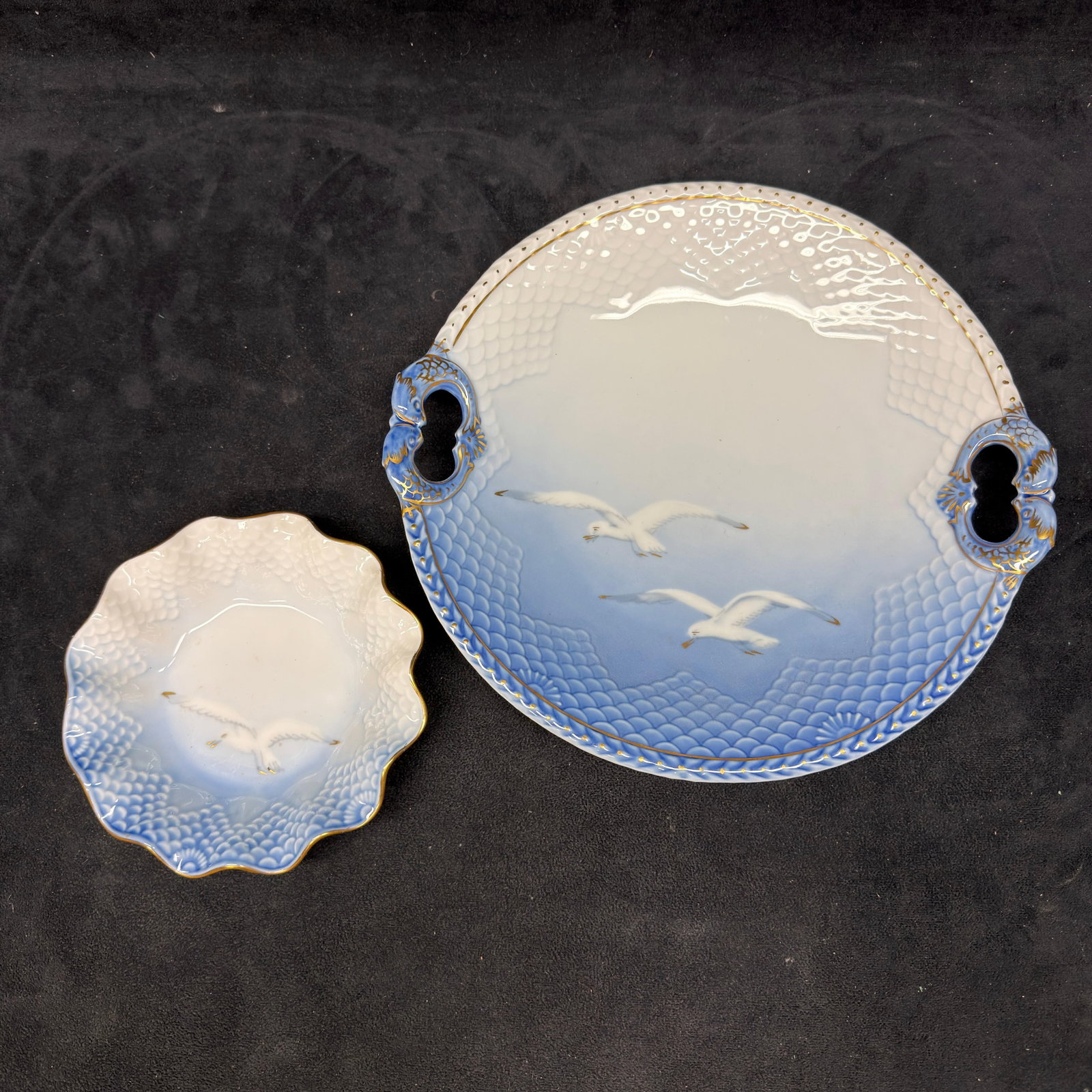 Royal Copenhagen Seagull Porcelain Handled Tray and Scalloped Bowl Set: Lot of two Royal Copenhagen porcelain pieces including a handled serving tray and a scalloped bowl, both decorated with the classic seagull motif in blue and white, marked Royal Copenhagen, Made in De