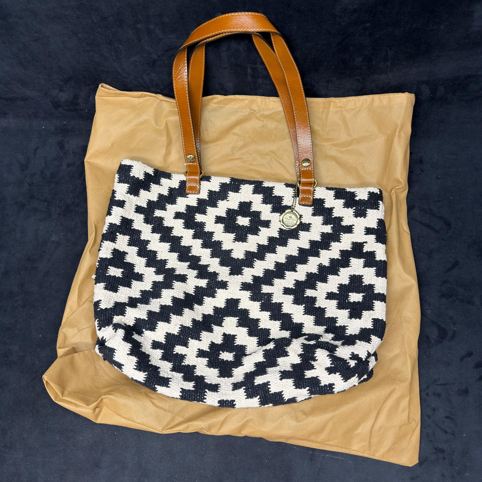 Patricia Nash Black and White Woven Tote Handbag with Leather Handles: Patricia Nash woven black and white geometric pattern tote handbag featuring dual leather shoulder straps, interior zip pocket, signature logo charm, and original Patricia Nash dust bag. Please refere