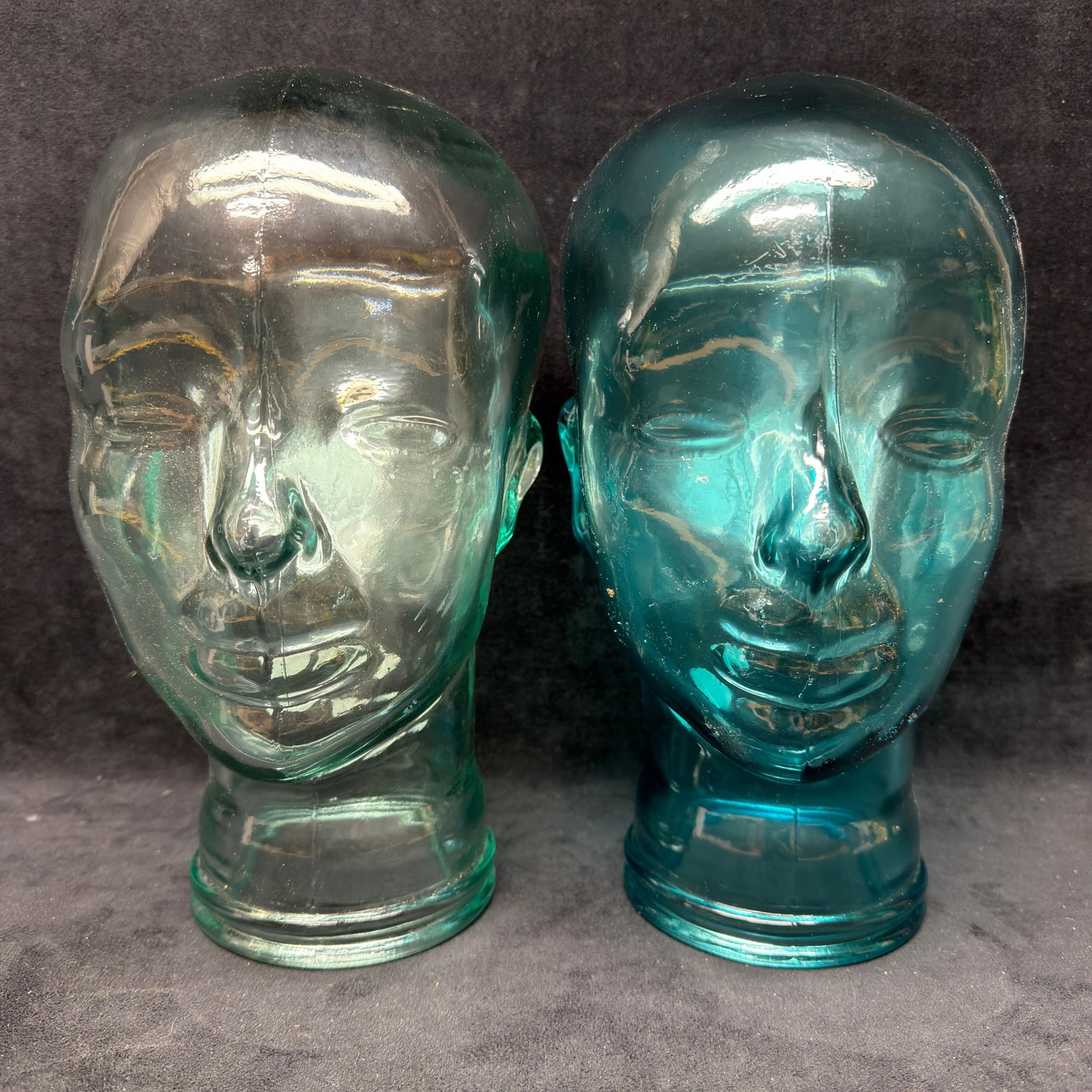 Pair of Vidrios San Miguel Recycled Glass Display Mannequin Heads Spain Blue Aqua Clear: Pair of hand-blown recycled glass mannequin display heads by Vidrios San Miguel, Spain. Includes one clear aqua-tinted example and one darker teal example, each retaining its original "Authentic 1