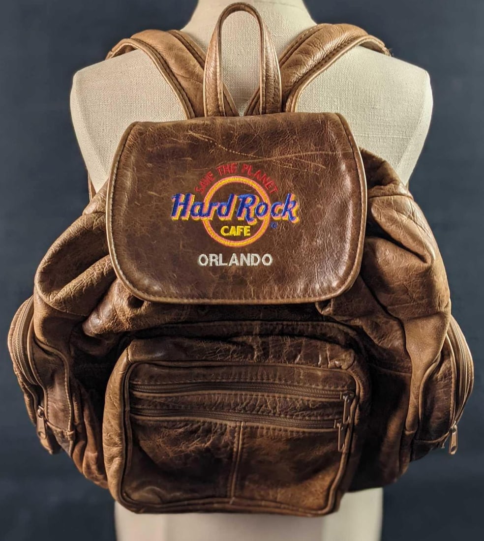 Rare Leather Hard Rock Cafe Orlando Employee Backpack Universal Studios: Was originally give only to opening day employees of the Hard Rock Cafe in Orlando, Florida, which was located at the Universal Studios entertainment complex. This Hard Rock was eventually closed and 