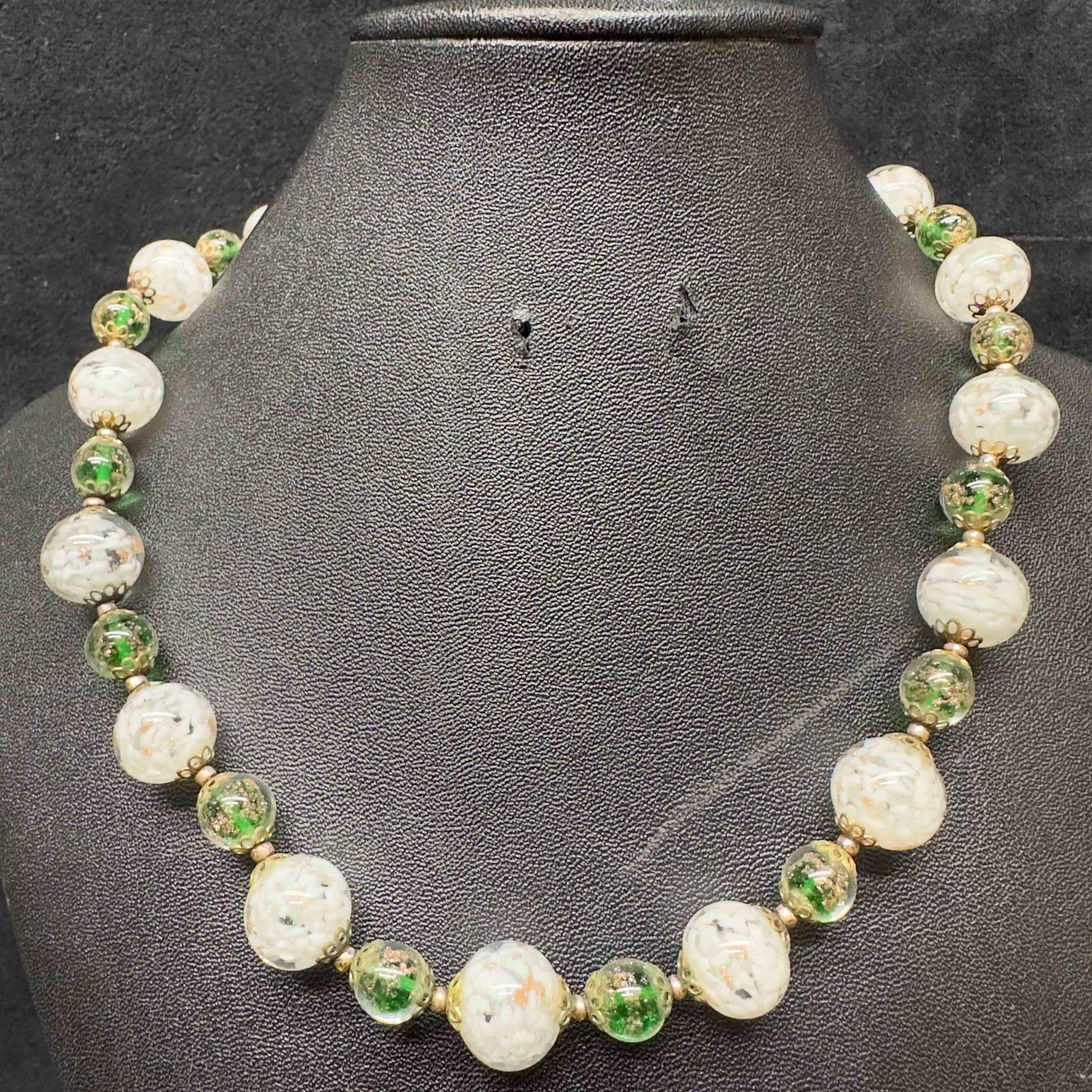 Venetian Murano Lamp Work Art Glass White Green Colored Copper Infused Beaded Necklace C34: Venetian Murano Lamp Work Art Glass White Green Colored Copper Infused Beaded Necklace C34. Necklace with green and white colored glass beads with beautiful designs on each. The necklace features copp