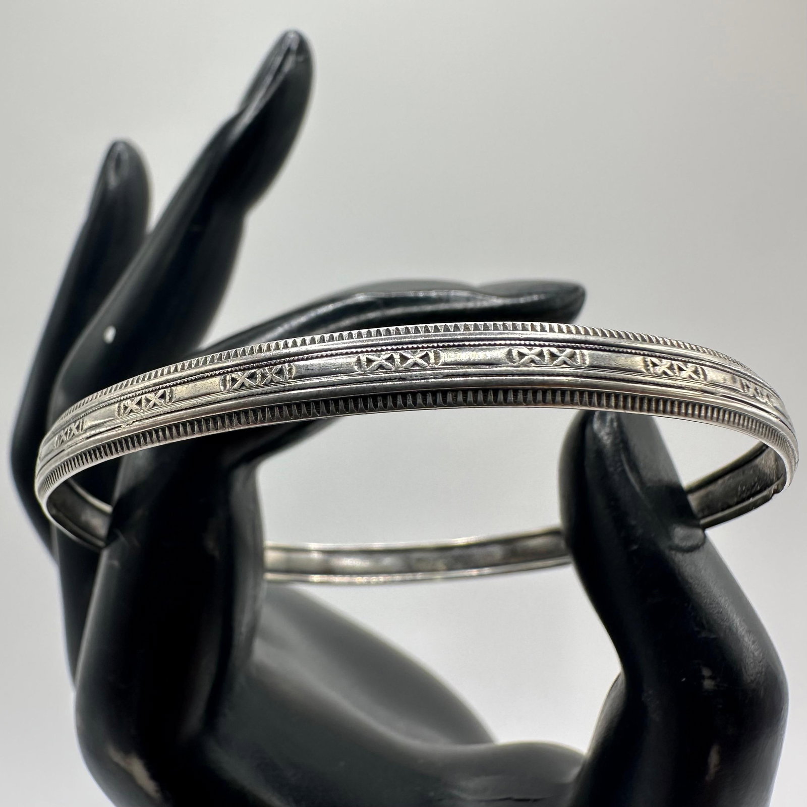 Silver Bangle Bracelet Double XX Pattern: This item is in good pre-owned, previously used/displayed condition with noticeable light wear and surface scratches. Please reference all photos for full details. This piece of jewelry has been teste
