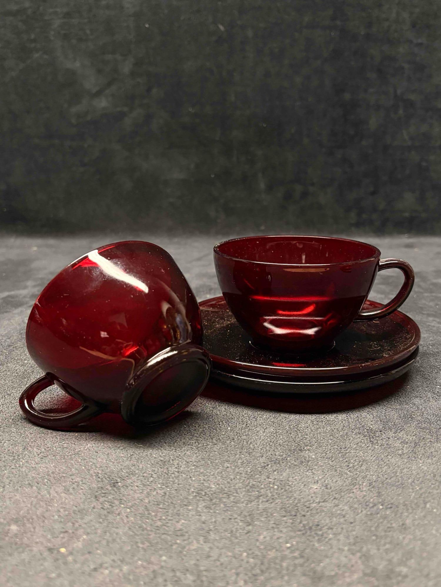 Set of Two Vintage Anchor Hocking Royal Ruby Red Glass Teacups and Saucers: This lot includes a set of two (2) Royal Ruby Teacups and Saucers from Anchor Hocking; a popular mid-20th-century glassware collection produced between roughly 1941 and 1969. This specific set is