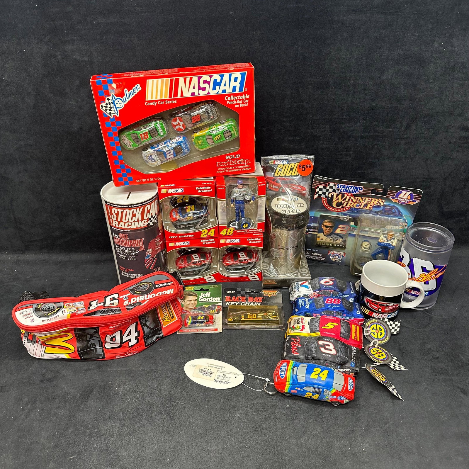 NASCAR Collector Lot Jeff Gordon Dale Earnhardt Jr. Jimmie Johnson and More: Mixed NASCAR memorabilia collection featuring die-cast cars, driver ornaments, mugs, travel mug set, Winner’s Circle figures, Stock Car Racing magazine, Jeff Gordon key chain, and NASCAR ca