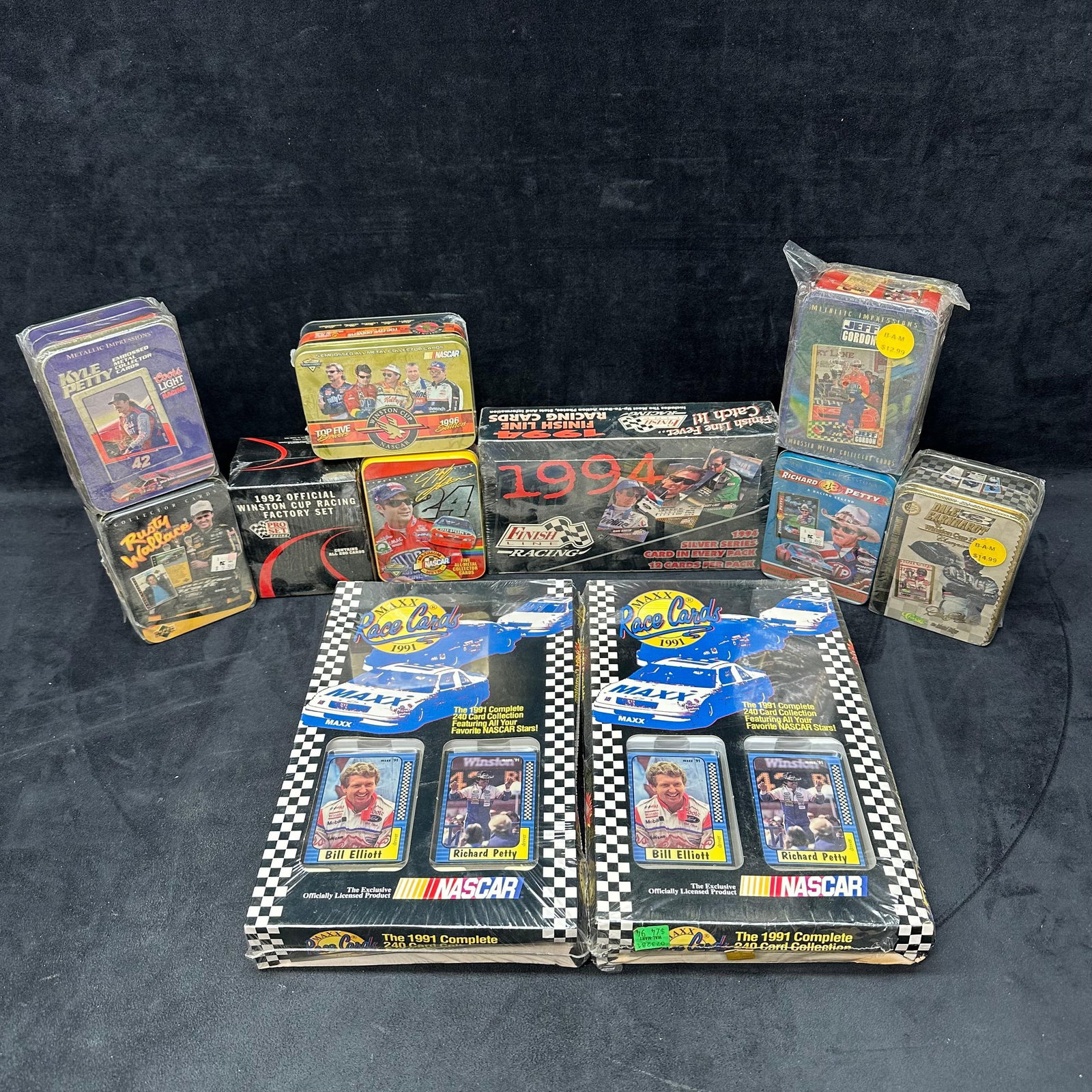 Large Lot of NASCAR Collectible Trading Card Sets Sealed Tins and Boxes 1991-96: Extensive collection of NASCAR trading card sets and tins from the early 1990s, featuring fan-favorite drivers and brands. Includes a mix of sealed sets and embossed collectible tins. Highlights inclu