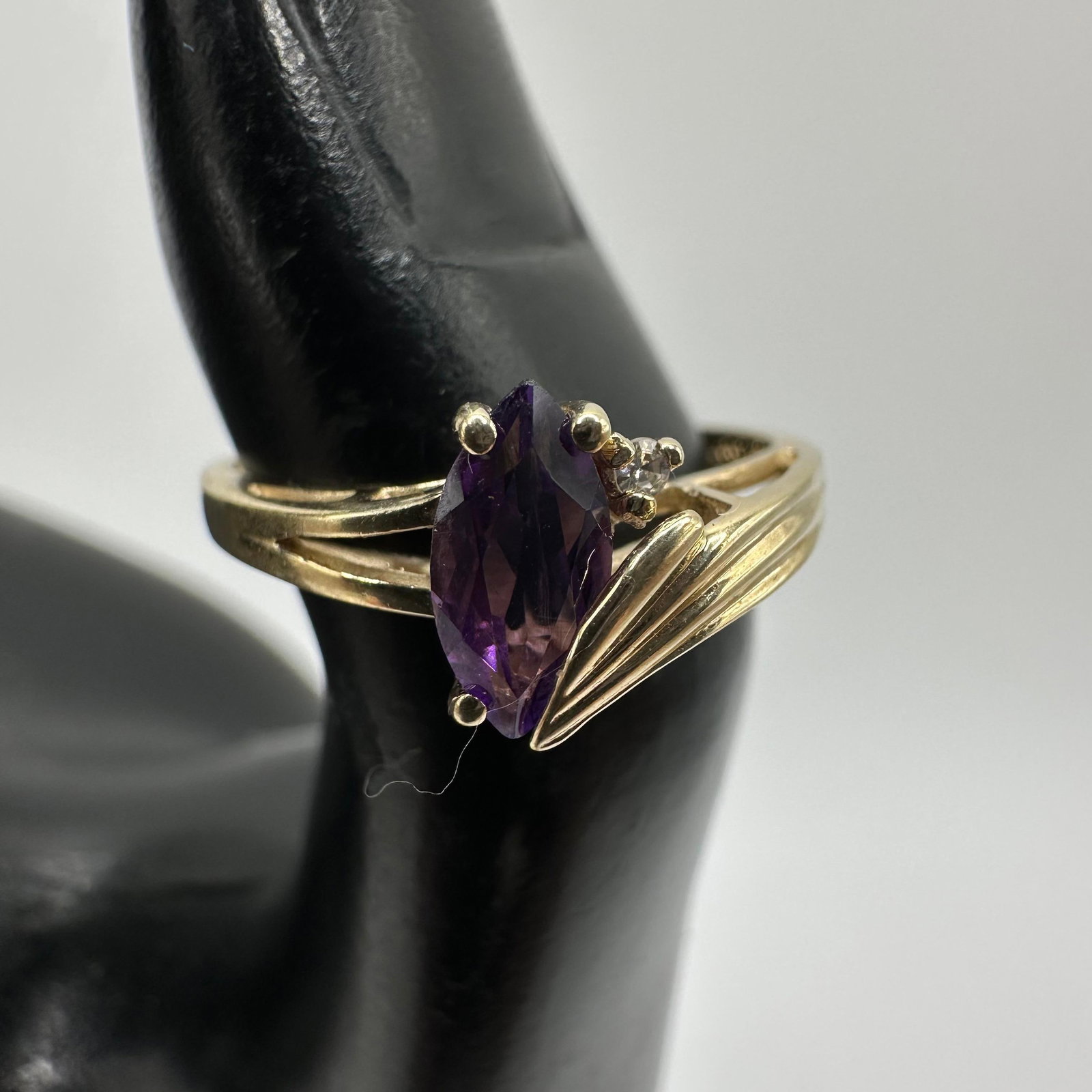 10K Gold Ring Marquise Cut Amethyst Round Accent Diamond: This item is in good pre-owned, previously used/displayed condition with noticeable light wear and surface scratches. Please reference all photos for full details. This piece of jewelry has been teste