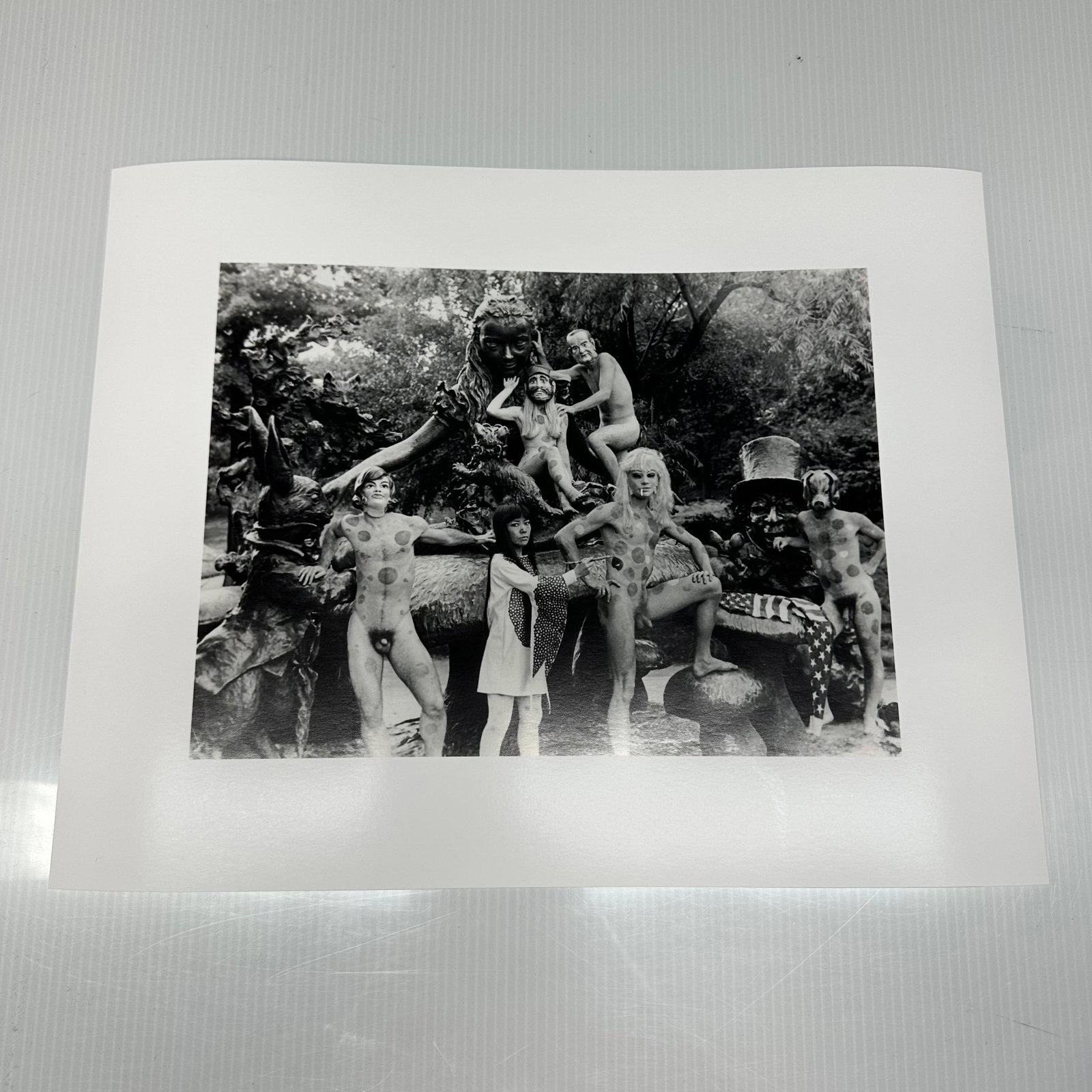 Yayoi Kusama Black and White Photo Print Nude Anatomic Explosion Happening: Black and white photographic print depicting Yayoi Kusama posed with polka-dotted nude models in an outdoor sculptural statue, Alice in Wonderland, setting in New York's Central