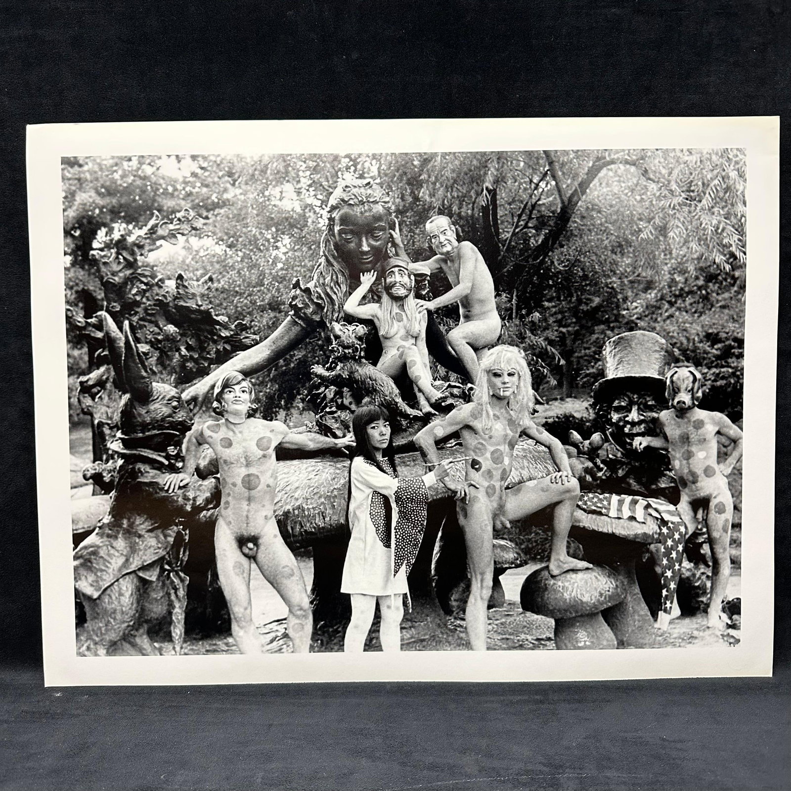 Yayoi Kusama Black and White Large Photo Print Alice In Wonderland Statue: Large black and white photographic print depicting Yayoi Kusama posed with polka-dotted nude models in an outdoor sculptural statue, Alice in Wonderland, setting in New York's Central Park. Print 
