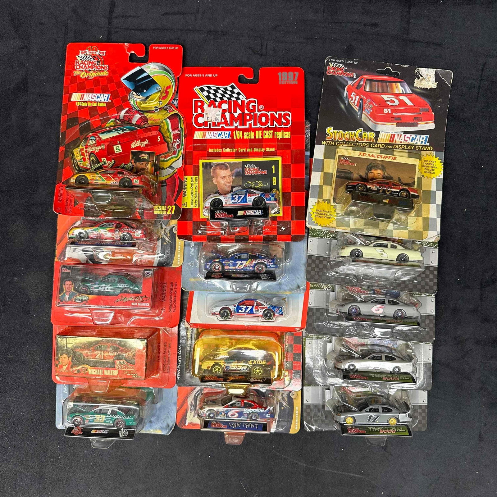 Racing Champions NASCAR Die-Cast Cars Mixed Series Fifteen Race Car Toys: Collection of Racing Champions NASCAR die-cast cars in original packaging. Includes a mix of series such as War Paint, Time Trial, Originals, and Stock Car with Collector’s Card. Featured
