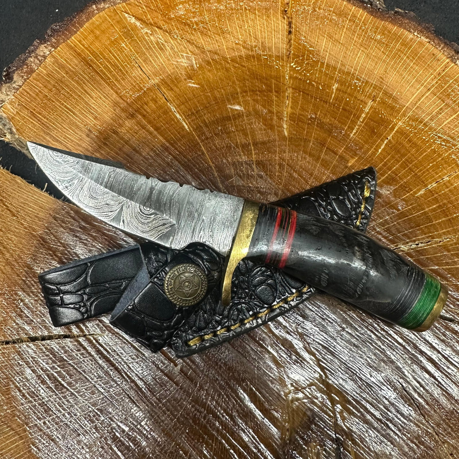 Short Fixed Blade Knife MHS Cutlery R38 with Leather Sheath: Fixed blade knife by MHS Cutlery featuring a textured steel blade and decorative spine work. The handle has a contoured, black epoxy resin/wood-style grip with metal mosaic accents. Includes a fitted 