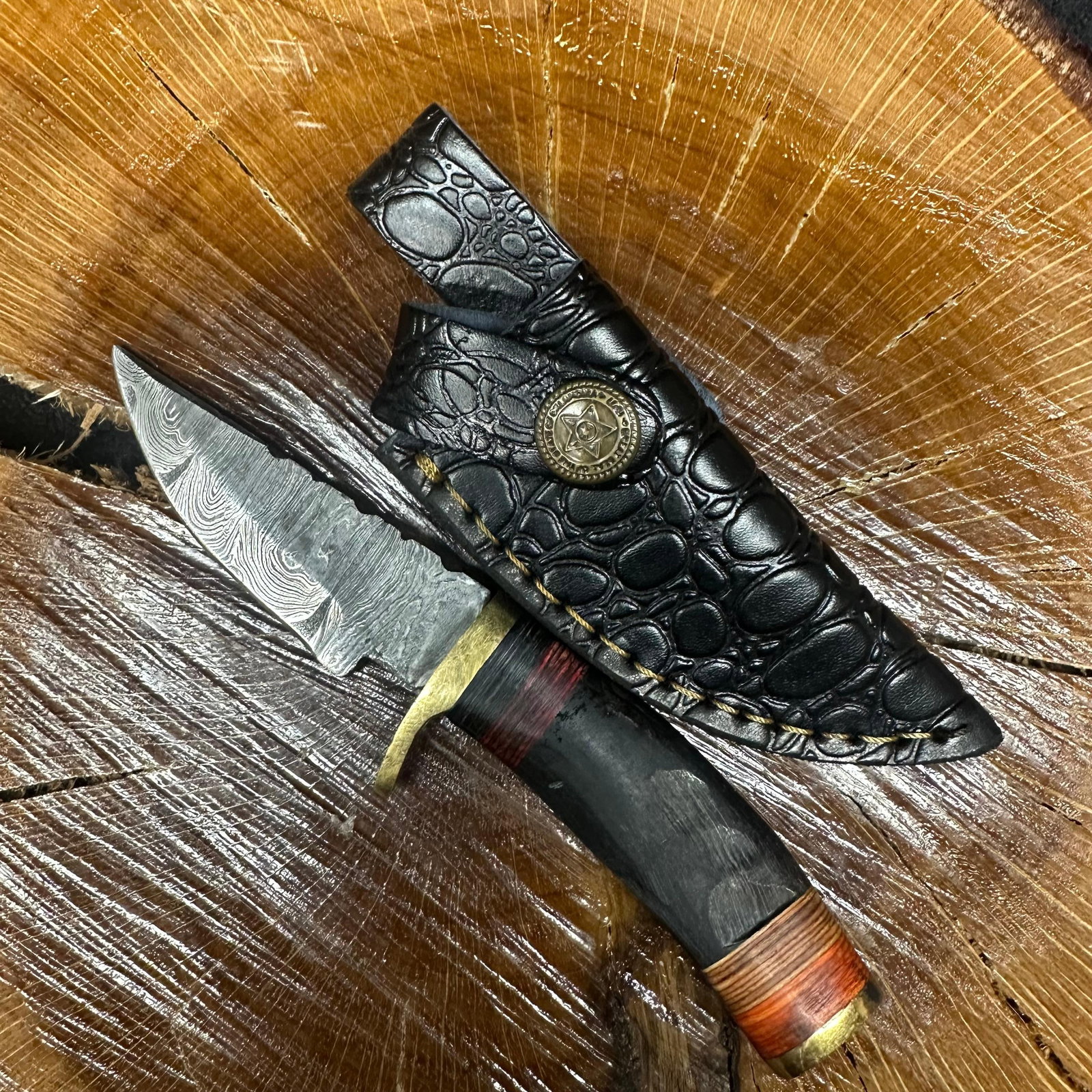 Small Fixed Blade Knife MHS Cutlery Curved Handle R35 with Sheath: Fixed blade knife by MHS Cutlery featuring a textured steel blade and decorative spine work. The handle has a contoured, black epoxy resin/wood-style grip with metal mosaic accents. Includes a fitted 