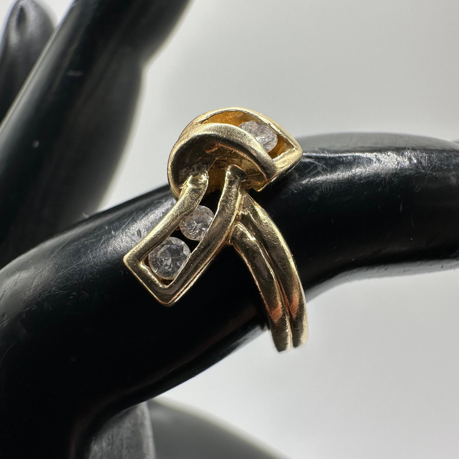 Three Accent Diamonds 14K Gold Ribbon Style Ring: This item is in good pre-owned, previously used/displayed condition with noticeable light wear and surface scratches. Please reference all photos for full details. This piece of jewelry has been teste