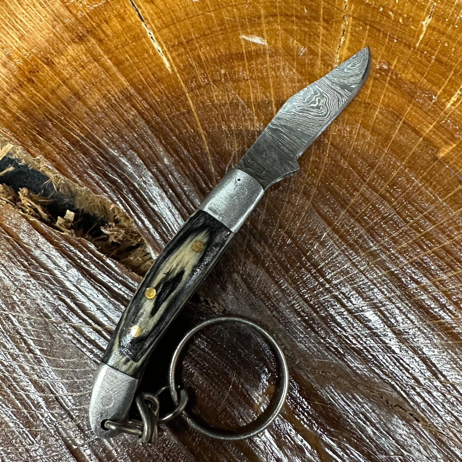 MHS Cutlery Keychain Steel Folding Blade Pocket Knife R55 Black: Small folding-blade pocket knife featuring a steel blade and a compact epoxy-resin/wood black colored handle secured with brass pins. Includes an attached metal key ring for easy carry. Good like-new 