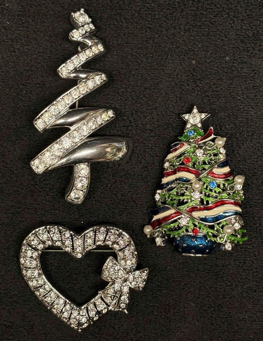 3pc Silver Tone Holiday Brooch Collection: This lot includes 3 silver-toned enamel brooches, featuring Christopher Radko's and Monet's holiday collection tree brooch. Each piece is in like-new conditions with little to no visible/notic