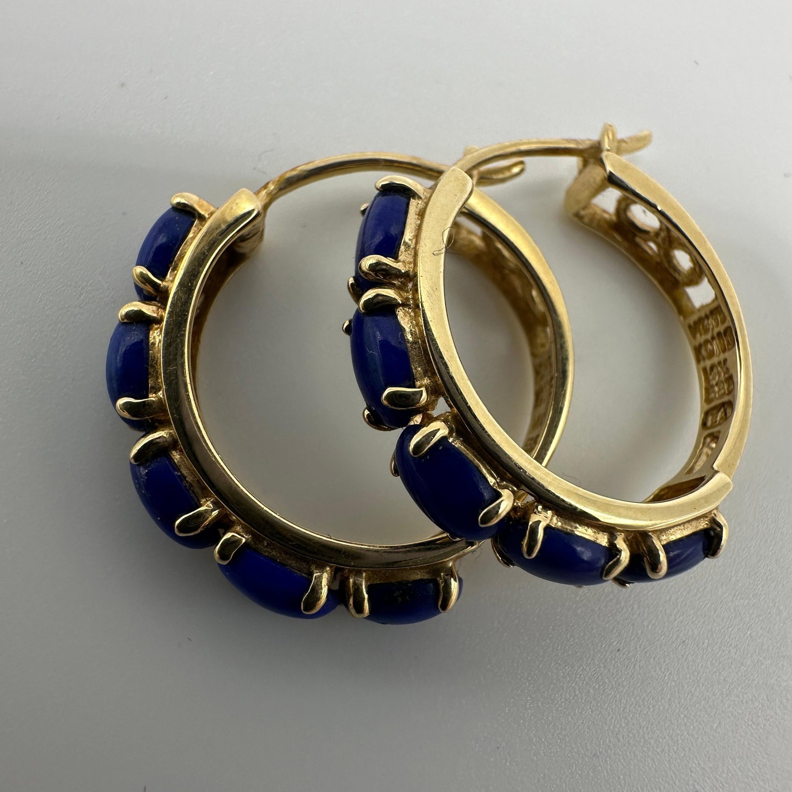 Blue Lapis Gemstones 14K Gold Hoop Earrings: This item is in good pre-owned condition, previously used/displayed, with noticeable light wear and surface scratches. Please reference all photos for full details. This piece of jewelry has been care