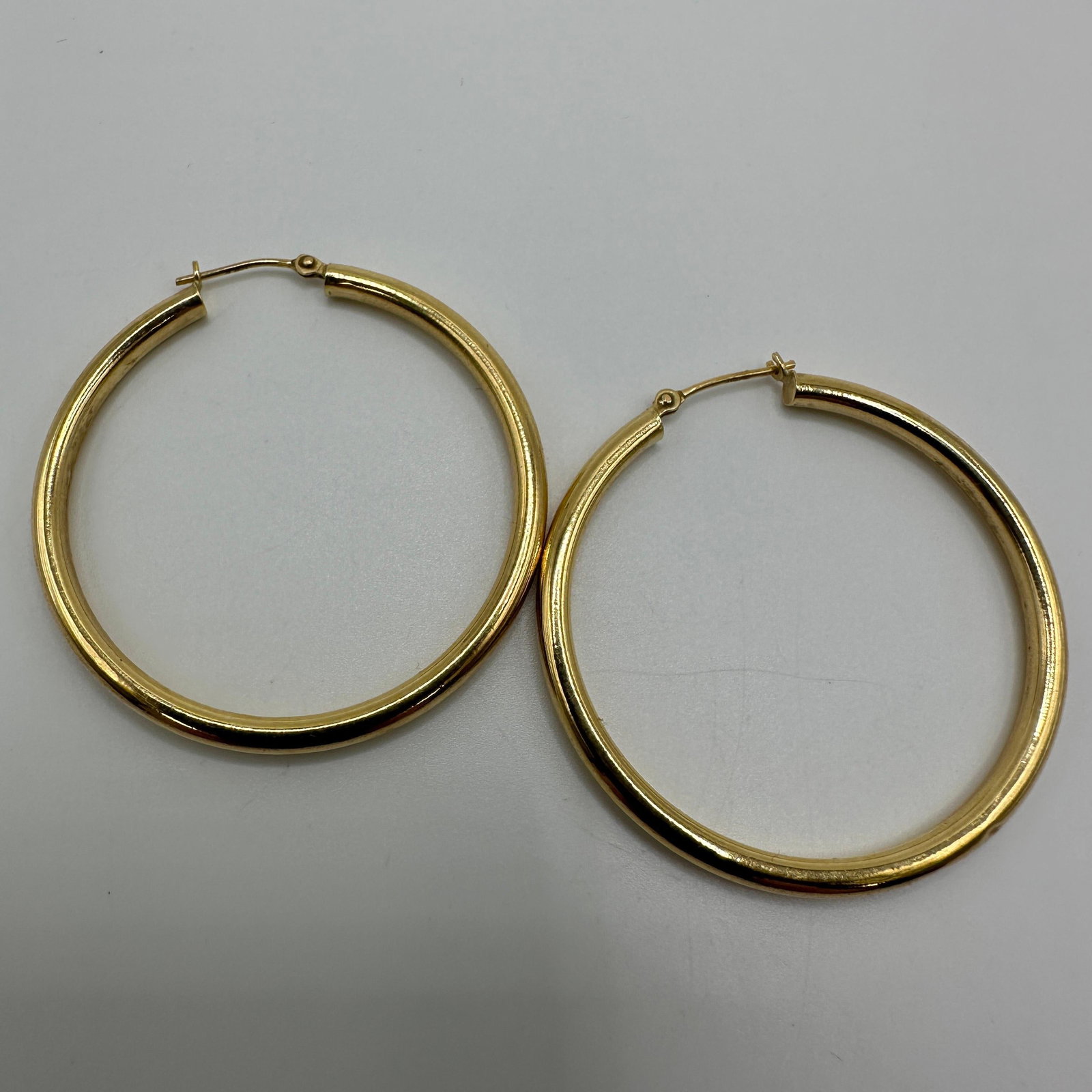 18K Yellow Gold Hoop Earrings 750 Hallmark A17: This item is in good pre-owned condition, previously used/displayed, with noticeable light wear and surface scratches. Please reference all photos for full details. This piece of jewelry has been care