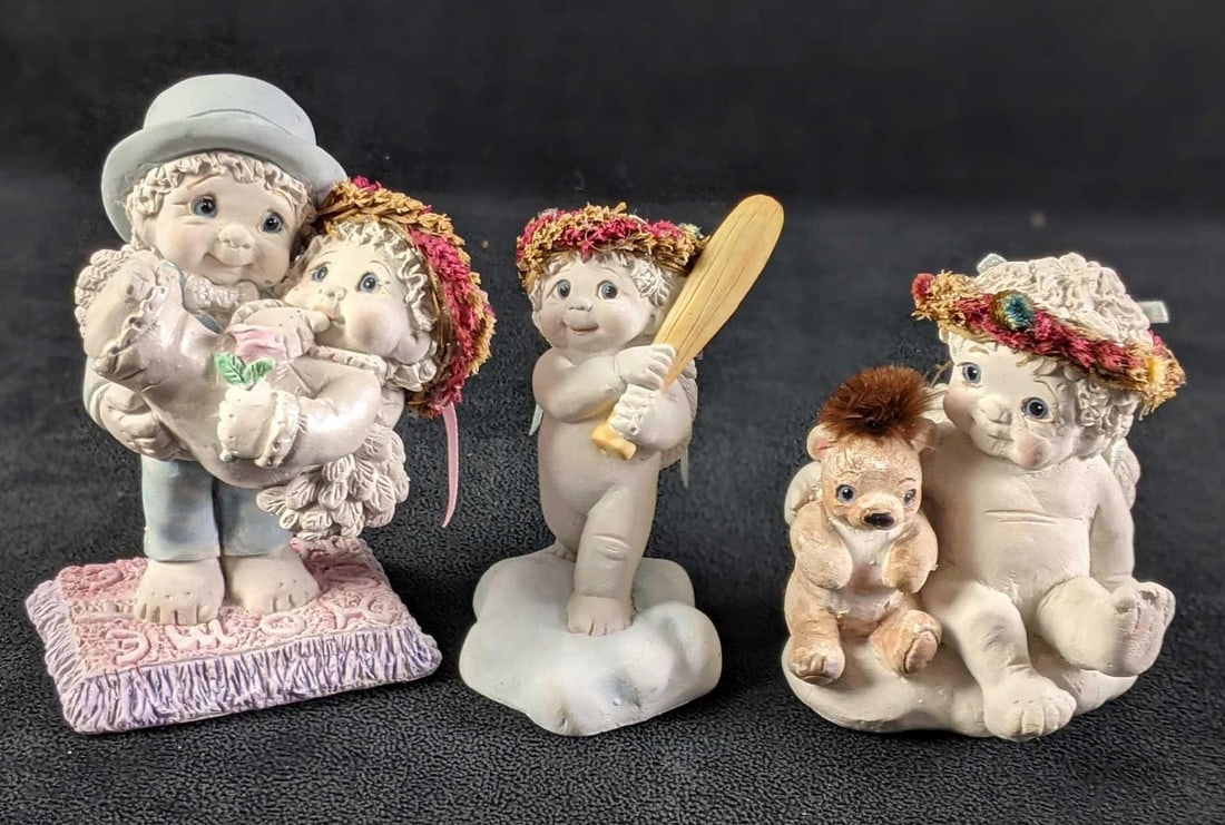 Three Dreamciles Baby Figurines (1) "Newlyweds" (2) "Team Player" (3) "Share the Fun": Three Dreamciles Baby Figurines (1) "Newlyweds" (2) "Team Player" (3) "Share the Fun" (1) "Newlyweds" Groom holding Bride. Good Condition, Slight wear on bottom and Gro