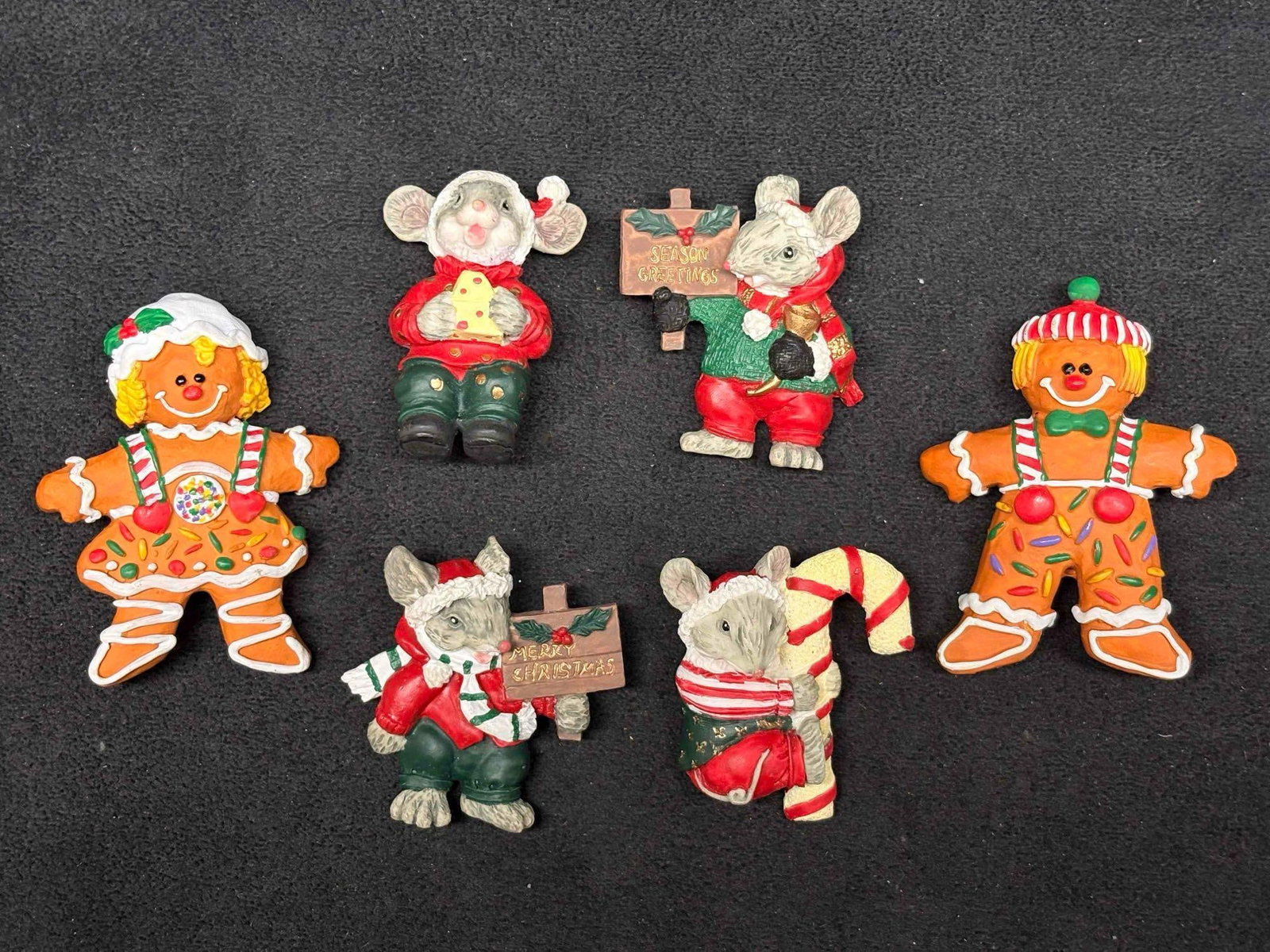 6pc 1990s Holiday Brooch Collection featuring Dezine Christmas Holly Jolly Christmas Mouse Figurines: These festive brooches are made of resin, displaying a cartoonish style popular in the 90s. This lot features the Dezine resin Holly Jolly Christmas mouses, paired with two (2) Gingerbread cookies. Wh