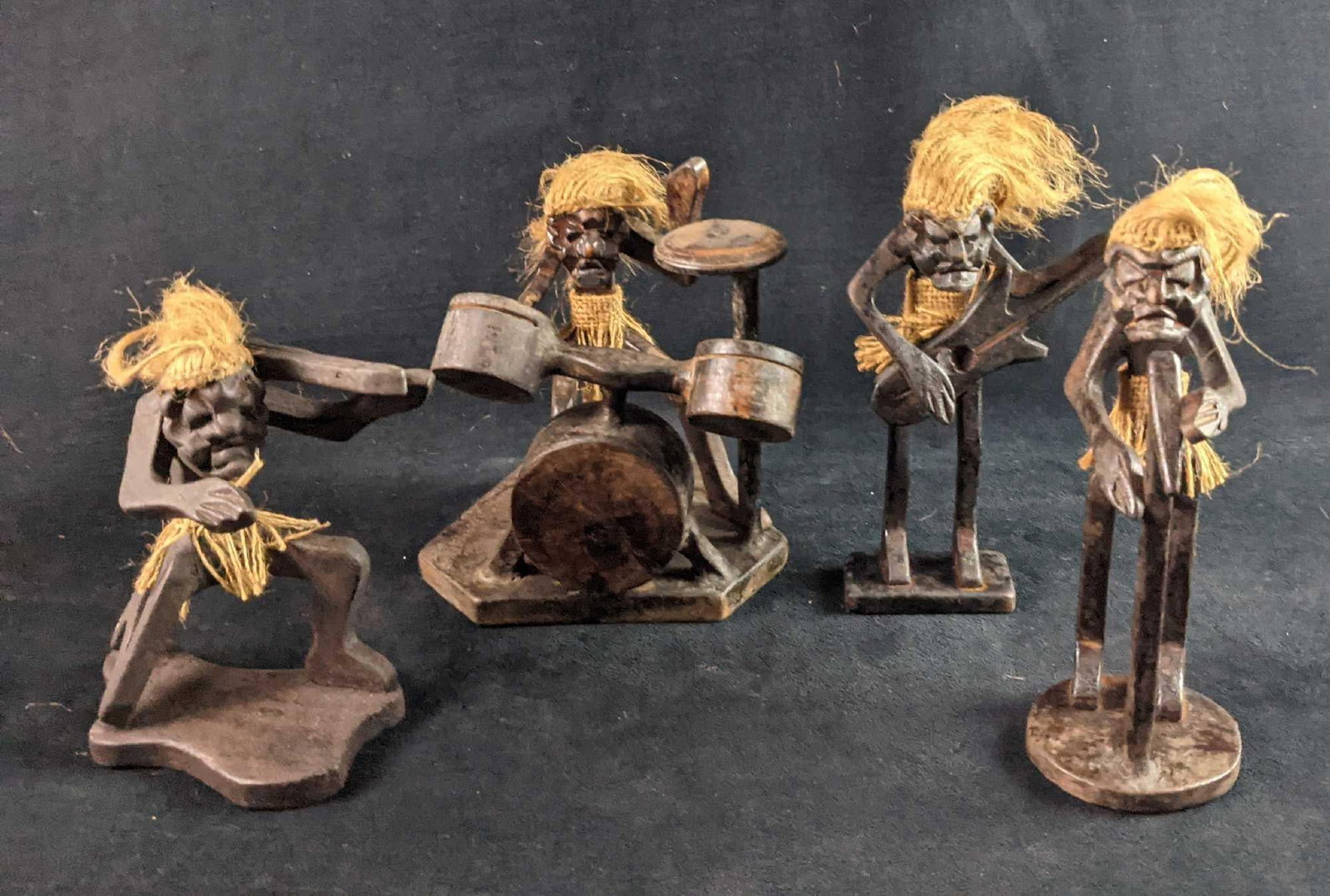 Vintage Primitive Wooden Tribal Statue Band: Hand carved albizia wood vintage primitive tribal statue band. Wooden body and straw hair and skirt. Made in Indonesia. This lot consists of: (1) Guitar Player. This is approx 6" x 1 1/2" x