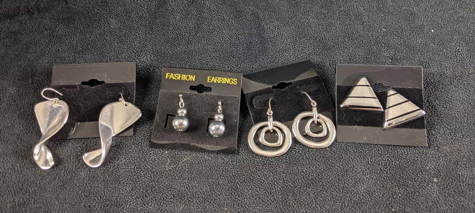 Earrings Silver Colored Pairs of Earrings: Earrings Silver Colored Pairs of Earrings This lot comes with four pairs of earrings. The earrings in this lot are like new most with backings and on earring labels. These are in good condition with