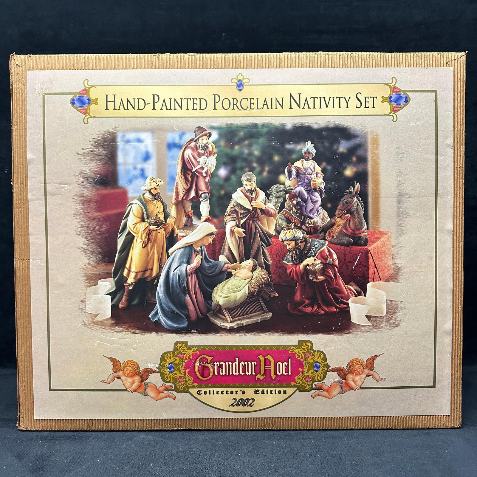 Grandeur Noel Collector's Edition Hand Painted Porcelain Nativity Set 2002: Hand-painted porcelain nativity set by Grandeur Noel, Collector’s Edition dated 2002. Includes multiple nativity figures with original molded styrofoam inserts and cardboard box. Figures appear 